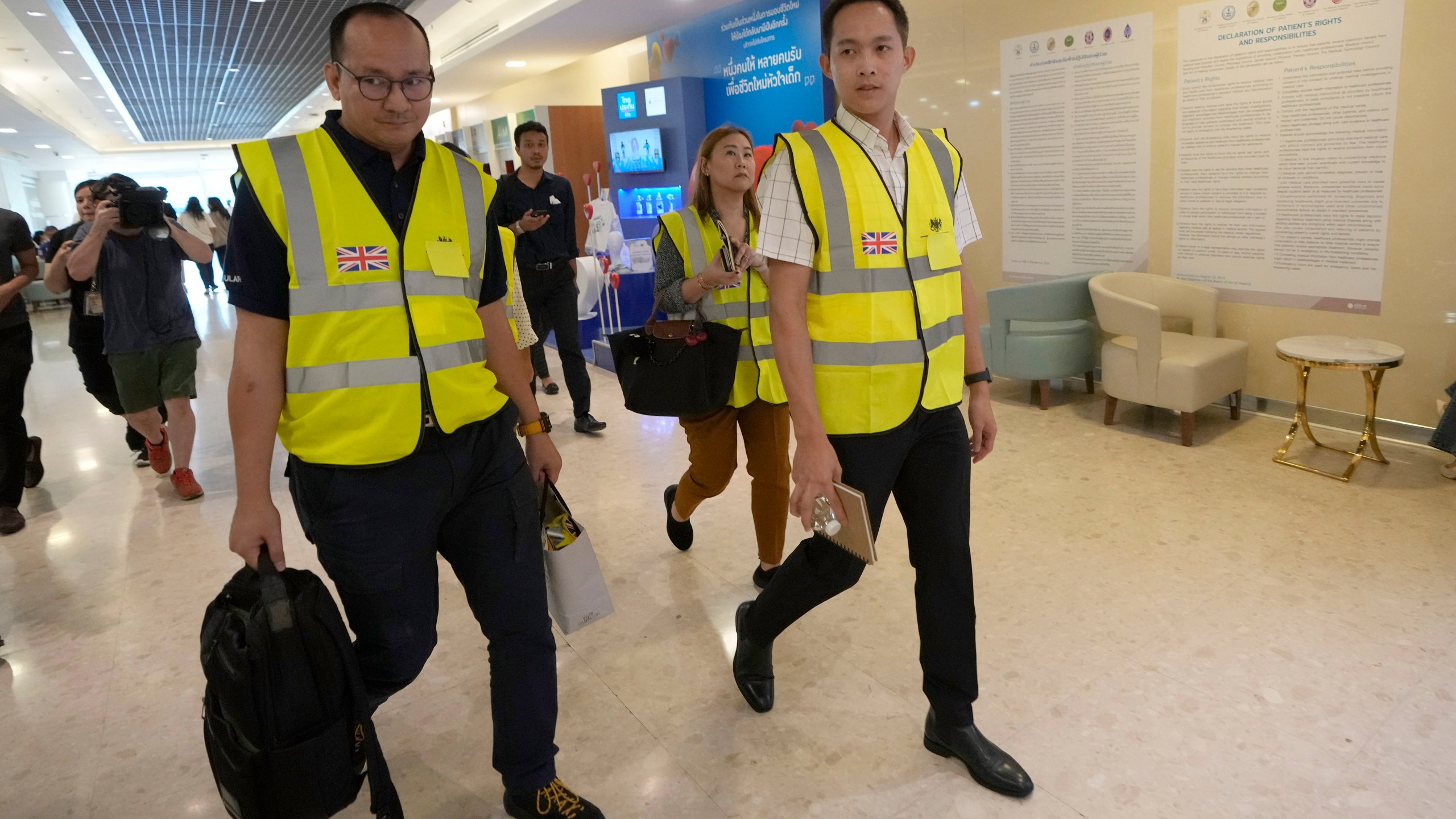 Staff members from the British Embassy arrive at Samitivej Srinakarin Hospital in Bangkok, Thailand, Wednesday, May 22, 2024, to visit passengers from Britain injured in the flight that hit severe turbulence over the Indian Ocean on Tuesday. The Singapore Airlines flight descended 6,000 feet (around 1,800 meters) in about three minutes, the carrier said Tuesday. A British man died and authorities said dozens of passengers were injured, some severely. (AP Photo/Sakchai Lalit)