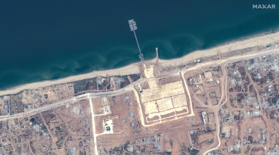 This image released by Maxar Technologies shows the overview of the new pier off Gaza and aid trucks on Saturday, May 18, 2024. (Satellite image ©2024 Maxar Technologies via AP)