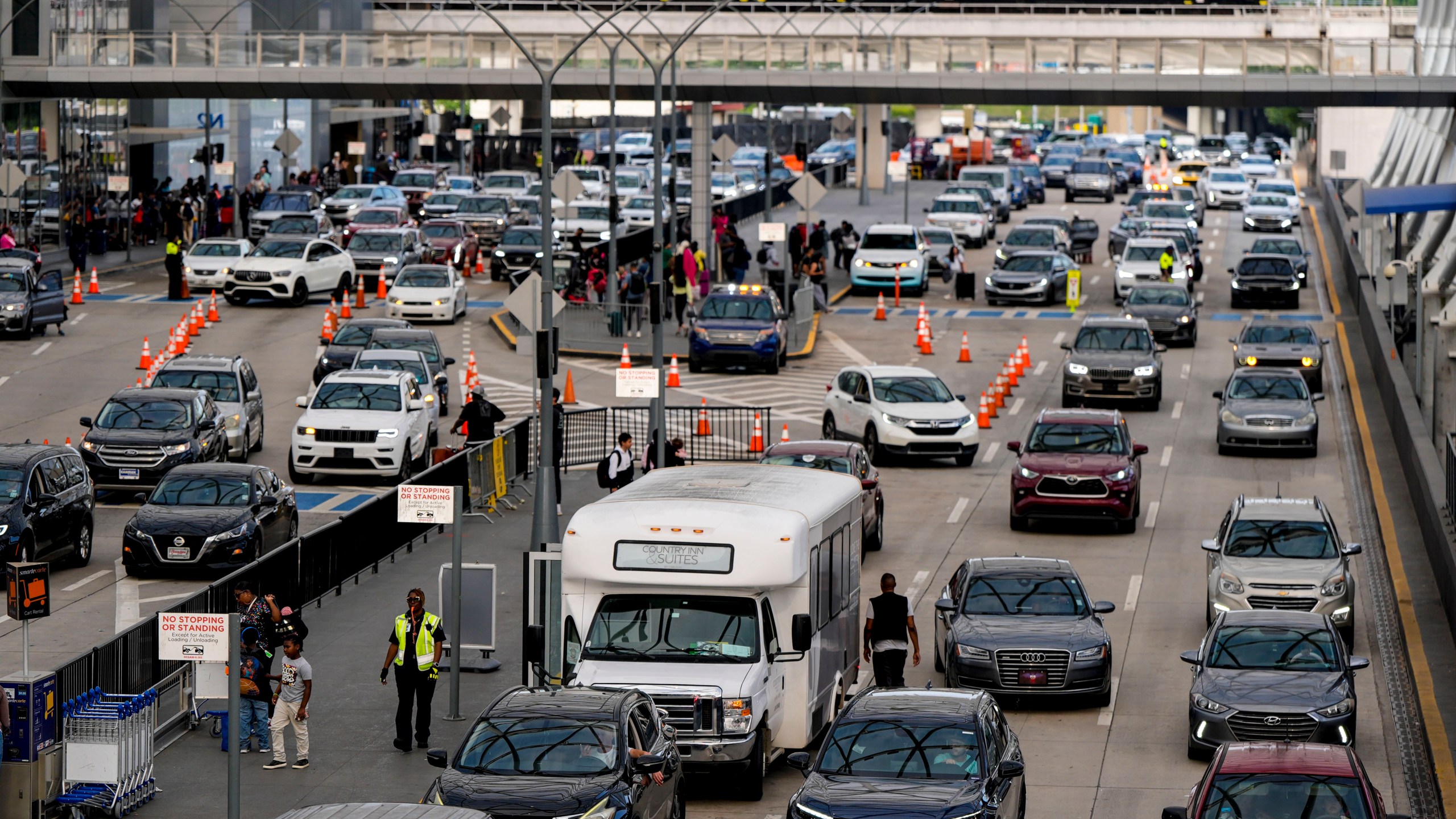 Cars drive through Hartsfield-Jackson Atlanta International Airport ahead of Memorial Day, Friday, May 24, 2024, in Atlanta (AP Photo/Mike Stewart)