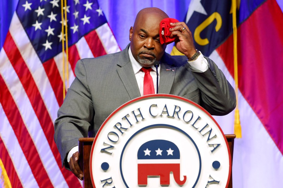 Lt. Gov. Mark Robinson wipes perspiration from his head as he speaks at the North Carolina GOP Convention.