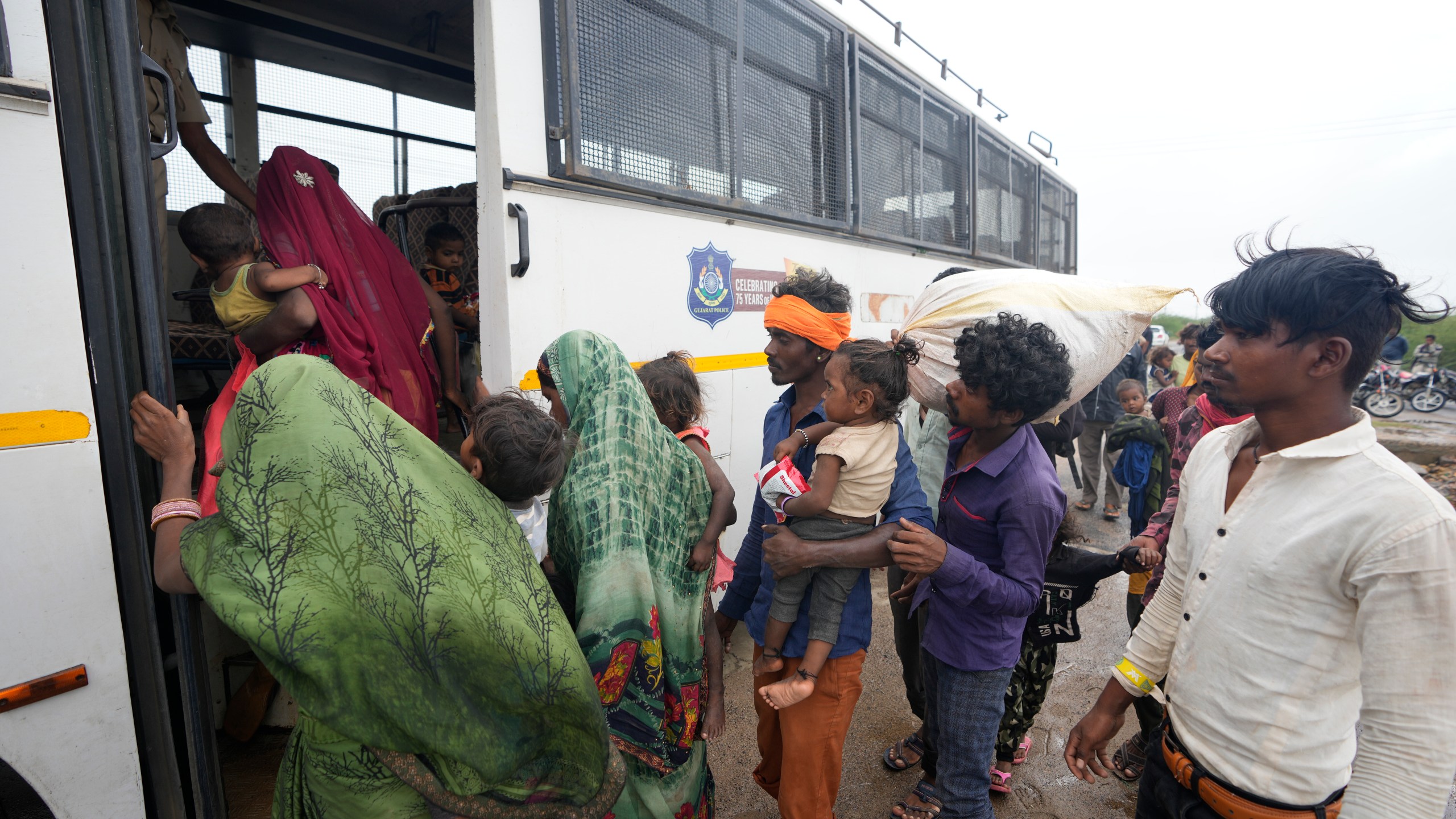 FILE - People evacuated from a village near Jakhau board a bus to travel to a shelter in Kutch district, India, Wednesday, June 14, 2023. A top United Nations official says even though climate change makes disasters such as cyclones, floods and droughts more intense, more frequent and striking more places, fewer people are dying from those catastrophes globally. Thats because of better warning, planning and resilience. (AP Photo/Ajit Solanki, File)