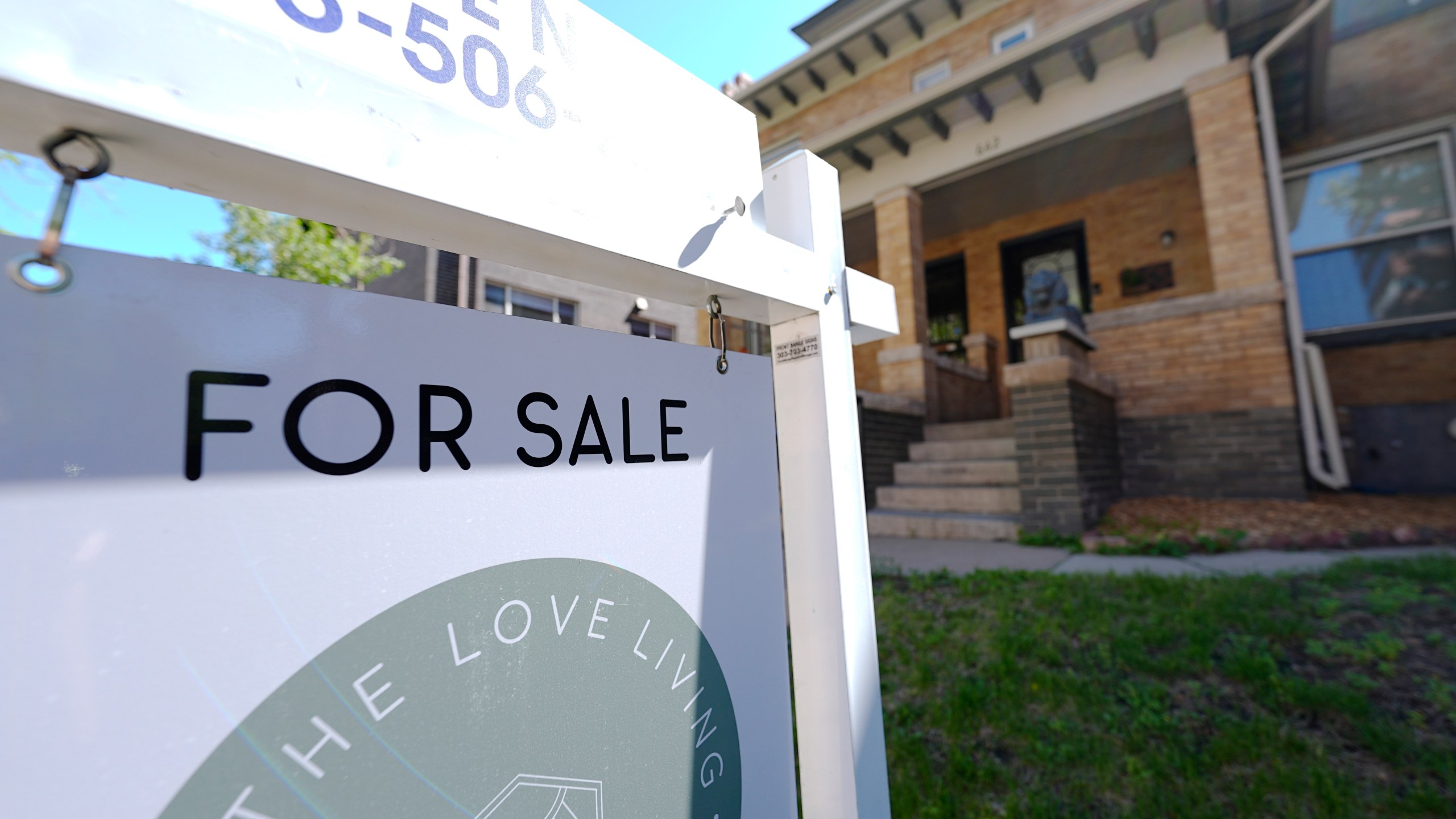 A sale sign stands outside a duplex on the market Friday, May 24, 2024, in downtown Denver. On Thursday, June 6, 2024, Freddie Mac reports on this week's average U.S. mortgage rates. (AP Photo/David Zalubowski)