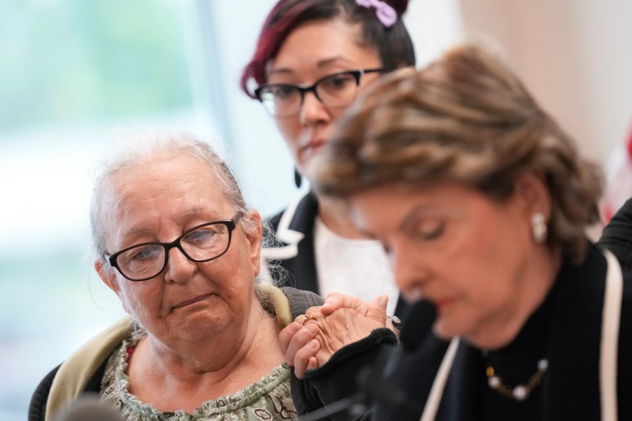 Jessica Taylors' mother, Elizabeth Baczkiel, left, listens as attorney Gloria Allred, right, reads her statement during a news conference in Riverhead, N.Y., Thursday, June 6, 2024. Rex Heuermann, previously accused of killing four women and leaving their corpses scattered along a coastal highway, was charged Thursday, in the deaths of two more, Taylor and Sandra Costil, after prosecutors said they gathered new DNA evidence and found a computer document he had used to "blueprint" his crimes. (AP Photo/Seth Wenig)