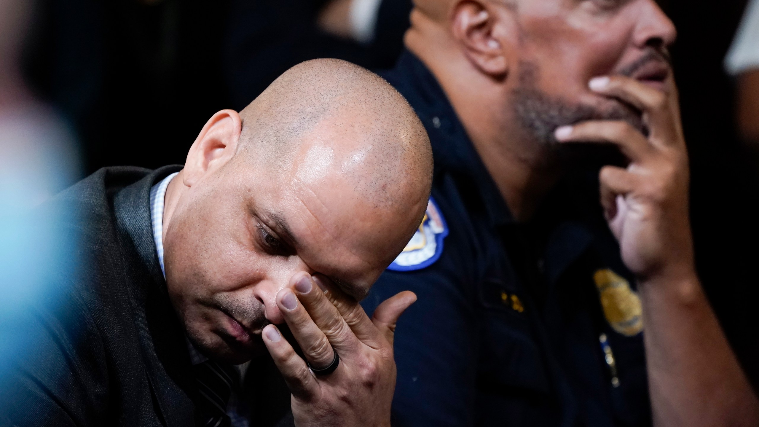 FILE - U.S. Capitol Police Sgt. Aquilino Gonell, left, and U.S. Capitol Police Sgt. Harry Dunn react as they watch a video as the House select committee investigating the Jan. 6, 2021, attack on the U.S. Capitol holds a hearing on Capitol Hill in Washington, Oct. 13, 2022. A visit to the Pennsylvania House floor by the two former police officers who helped protect the U.S. Capitol during the Jan. 6 riot drew boos and walkouts by some Republican members on Wednesday, June 5, 2024, as the chamber was wrapping up business for the week. (AP Photo/Jacquelyn Martin, File)