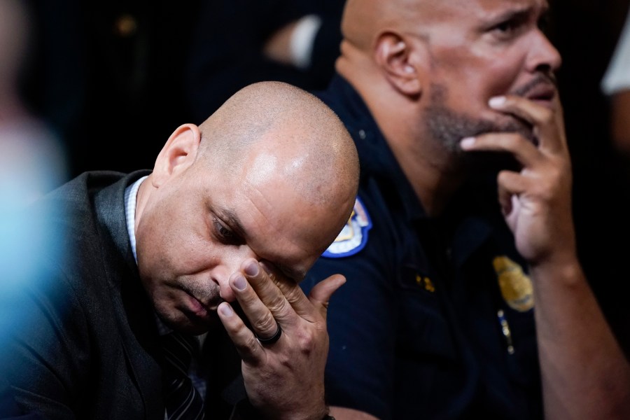 FILE - U.S. Capitol Police Sgt. Aquilino Gonell, left, and U.S. Capitol Police Sgt. Harry Dunn react as they watch a video as the House select committee investigating the Jan. 6, 2021, attack on the U.S. Capitol holds a hearing on Capitol Hill in Washington, Oct. 13, 2022. A visit to the Pennsylvania House floor by the two former police officers who helped protect the U.S. Capitol during the Jan. 6 riot drew boos and walkouts by some Republican members on Wednesday, June 5, 2024, as the chamber was wrapping up business for the week. (AP Photo/Jacquelyn Martin, File)