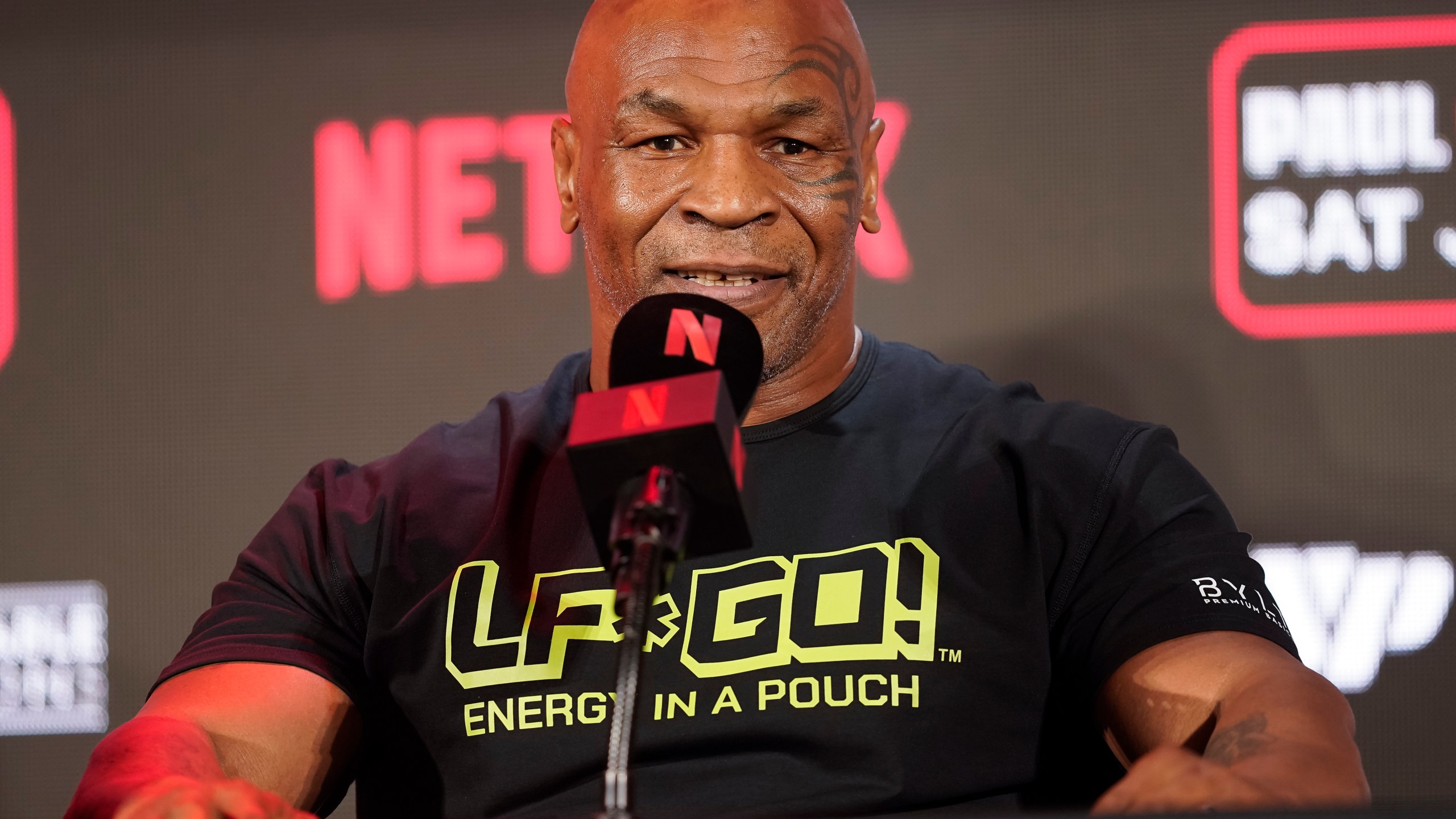 FILE - Mike Tyson speaks during a news conference promoting his upcoming boxing bout against Jake Paul, May 16, 2024, in Arlington, Texas. Tyson was recovering Monday, May 27, after suffering a medical emergency a day earlier during a flight from Miami to Los Angeles, his representatives said. The 58-year-old boxing legend “became nauseous and dizzy due to an ulcer flare up 30 minutes before landing” his publicist's office said in a statement. (AP Photo/Sam Hodde, File)