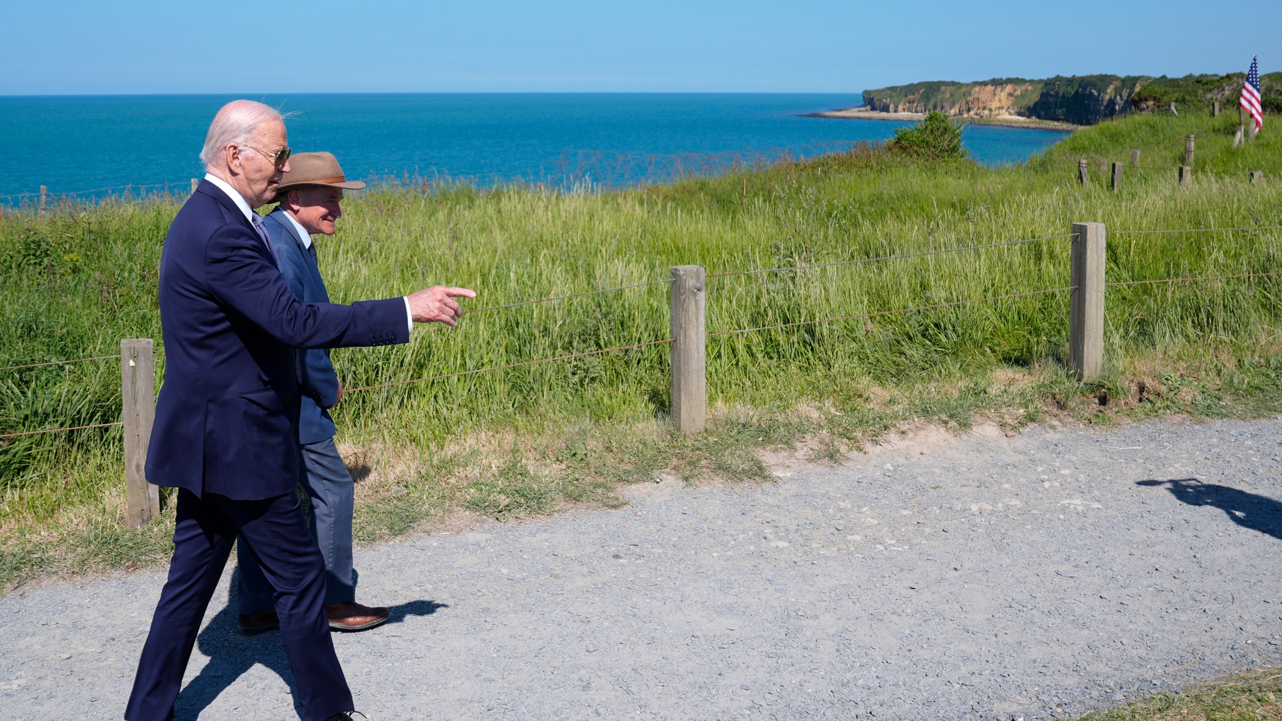 President Joe Biden walks with Scott Desjardins, superintendent of Normandy American Cemetery and Pointe du Hoc, after delivering a speech on the legacy of Pointe du Hoc, and democracy around the world, Friday, June 7, 2024, in Normandy, France. (AP Photo/Evan Vucci)