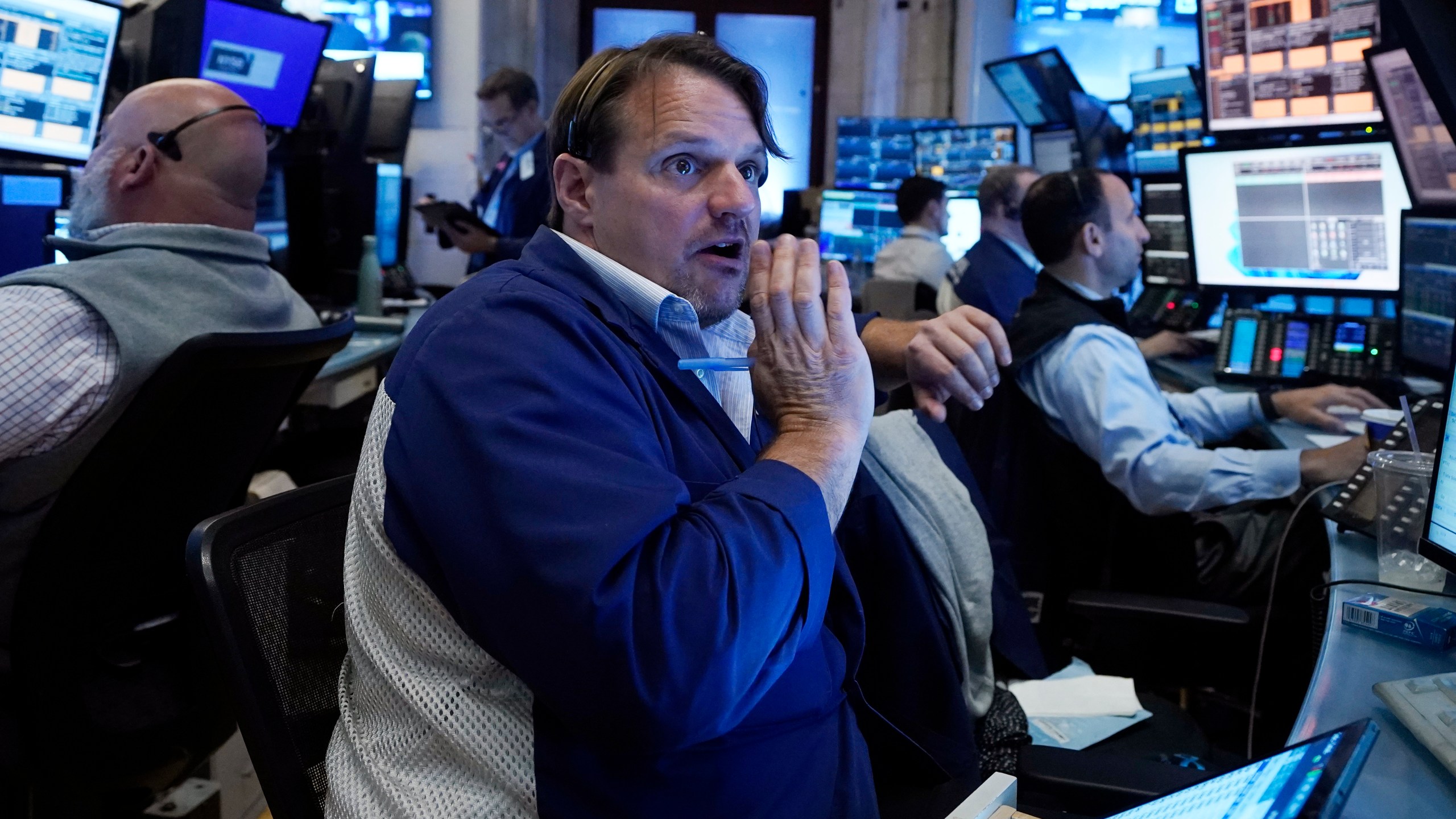 FILE - Trader Michael Milano, center, works with colleagues on the floor of the New York Stock Exchange on May 30, 2024. World stocks are mixed on Friday, June 7, 2024, after a steady day on Wall Street as markets anticipate key U.S. jobs data to be revealed later in the day. (AP Photo/Richard Drew, File)