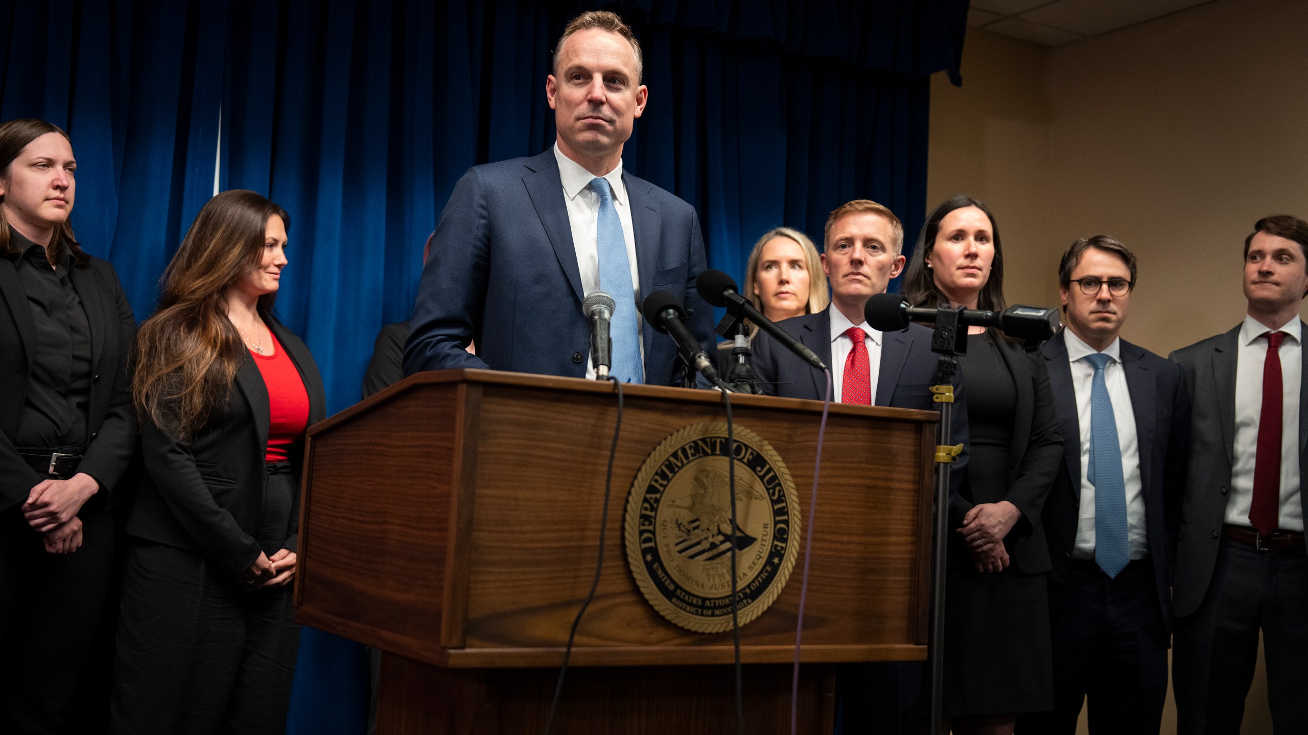 Assistant U.S. Attorney Joe Thompson, surrounded by the prosecution's trial team, speaks during a news conference after the verdict was read in the first Feeding Our Future case at the federal courthouse in Minneapolis, Friday, June 7, 2024. A jury convicted five Minnesota residents and acquitted two others Friday for their roles in a scheme to steal more than $40 million that was supposed to feed children during the coronavirus pandemic. (Leila Navadi/Star Tribune via AP)