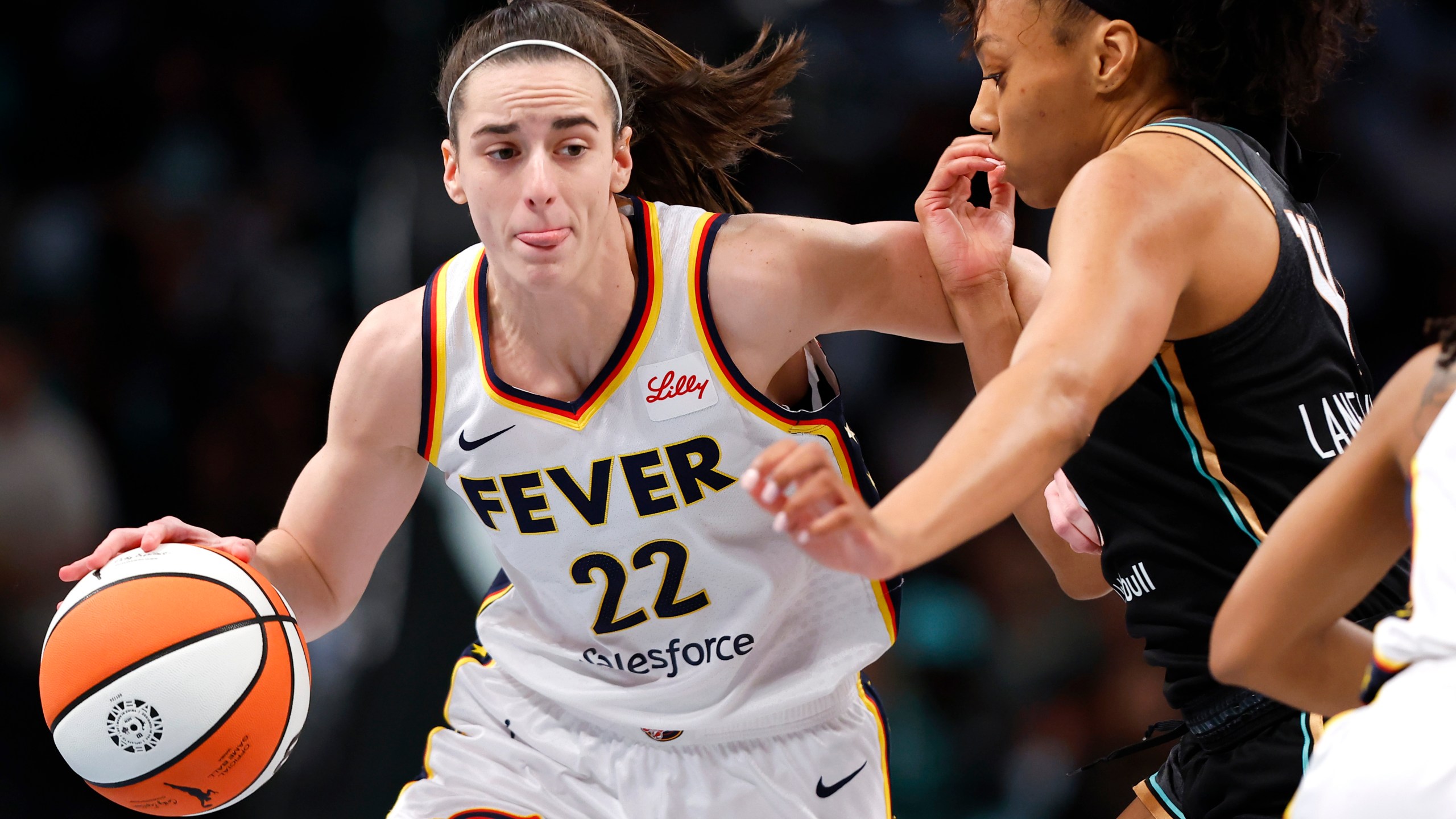 FILE - Indiana Fever guard Caitlin Clark (22) drives to the basket against New York Liberty forward Betnijah Laney-Hamilton (44) during the first half of a WNBA basketball game, Saturday, May 18, 2024, in New York. (AP Photo/Noah K. Murray, File)