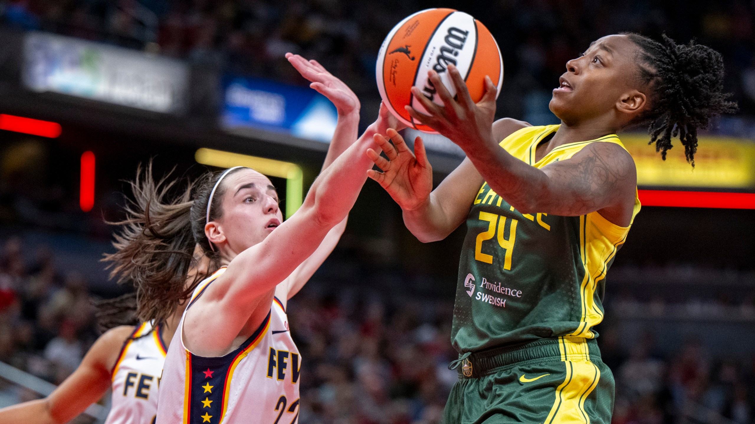 FILE - Seattle Storm guard Jewell Loyd (24) shoots against Indiana Fever guard Caitlin Clark (22) during the second half of a WNBA basketball game Thursday, May 30, 2024, in Indianapolis. (AP Photo/Doug McSchooler, File)