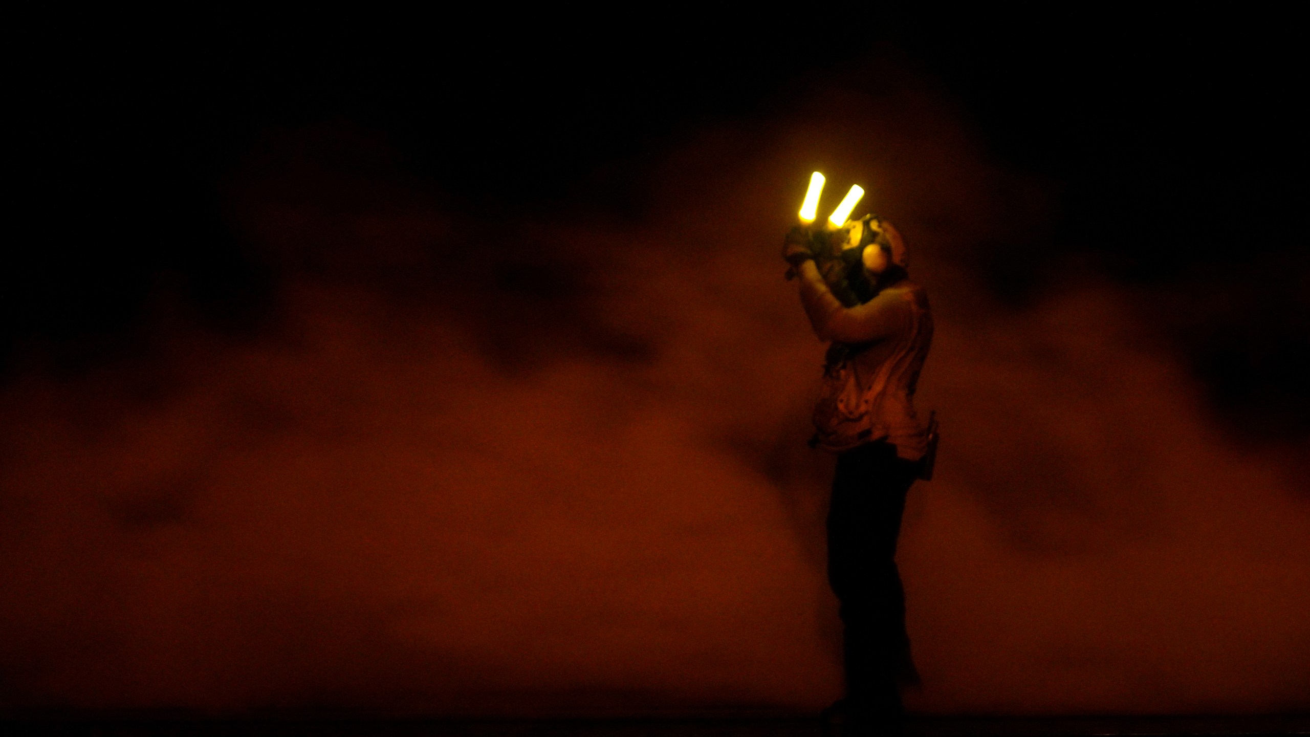 A sailor signals a fighter jet preparing to launch off the USS Dwight D. Eisenhower aircraft carrier in the Red Sea on Tuesday, June 11, 2024. (AP Photo/Jon Gambrell)