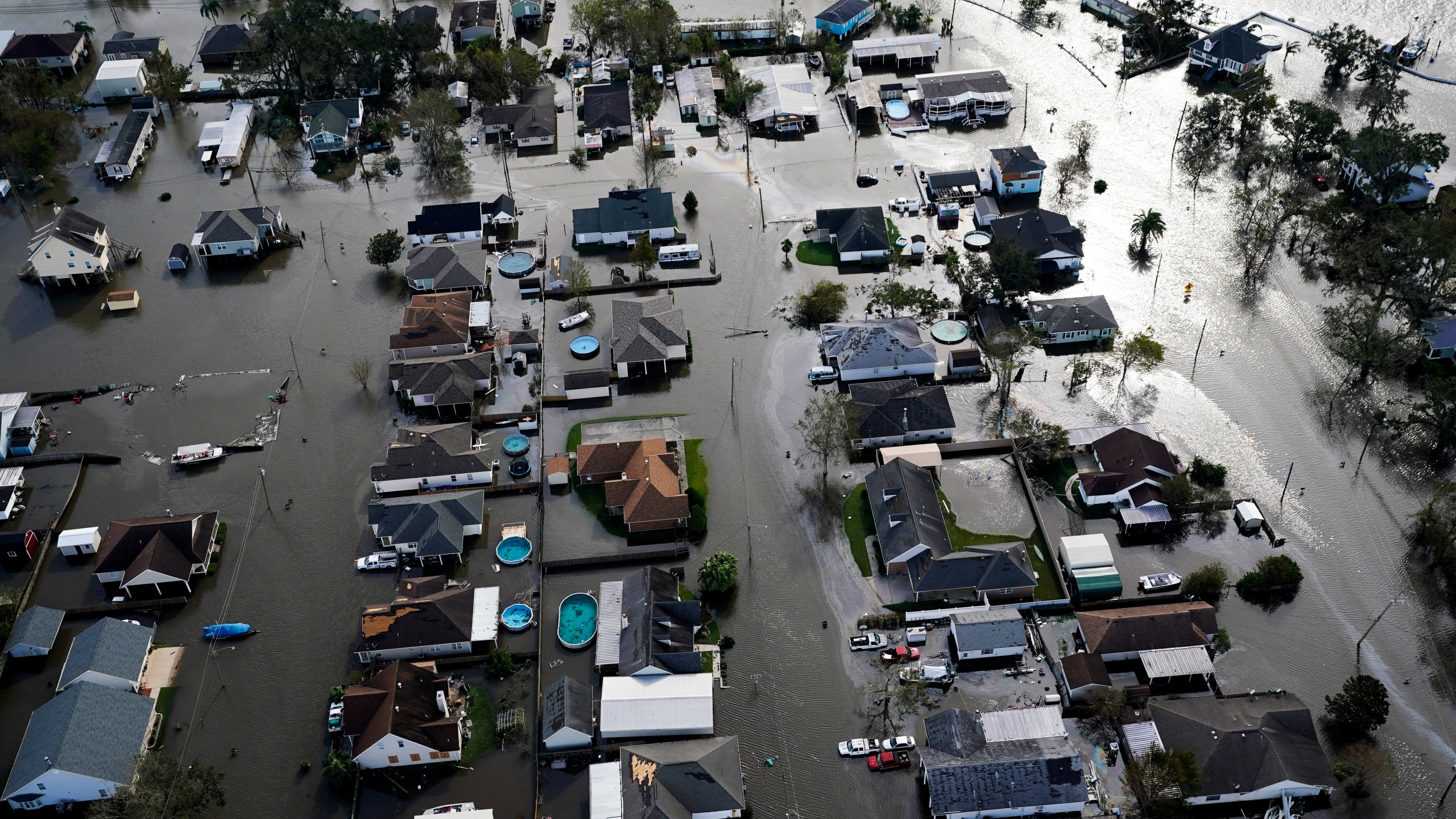 FILE - Homes are flooded in the aftermath of Hurricane Ida, Aug. 30, 2021, in Jean Lafitte, La. The National Oceanic Atmospheric Administration Thursday, June 13, 2024, pronounced dead the El Nino that warms parts of the central Pacific. Forecasters expect La Nina to breeze in just in time for peak Atlantic hurricane season. (AP Photo/David J. Phillip, File)