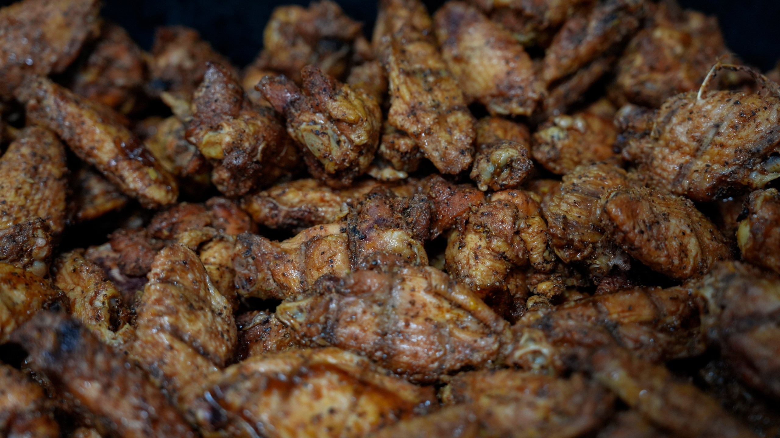 Chicken wings sit in a pan before frying, Wednesday, June 12, 2024, at a barbecue restaurant in Cincinnati. Psychologists have known for years now that men tend to eat more meat than women, but a study of people around the world now reveals that that's true across cultures. (AP Photo/Joshua A. Bickel)