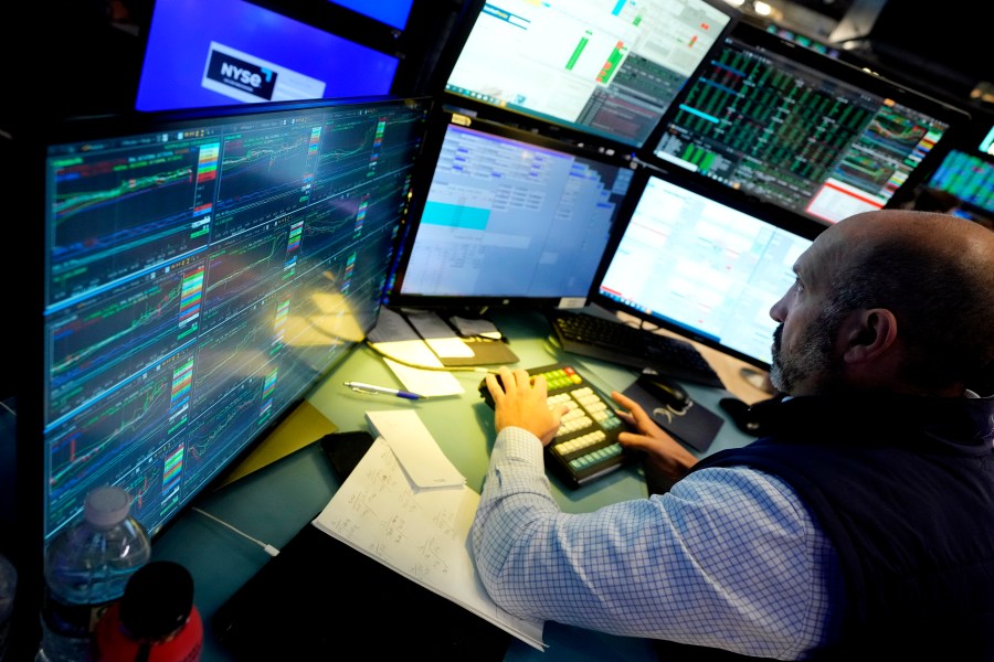 FILE - Specialist James Denaro works at his post on the floor of the New York Stock Exchange on June 12, 2024. Global shares were mixed on Friday, June 14, 2024, after Wall Street touched fresh records, with benchmarks pushed higher by the frenzy over artificial intelligence technology. (AP Photo/Richard Drew, File)