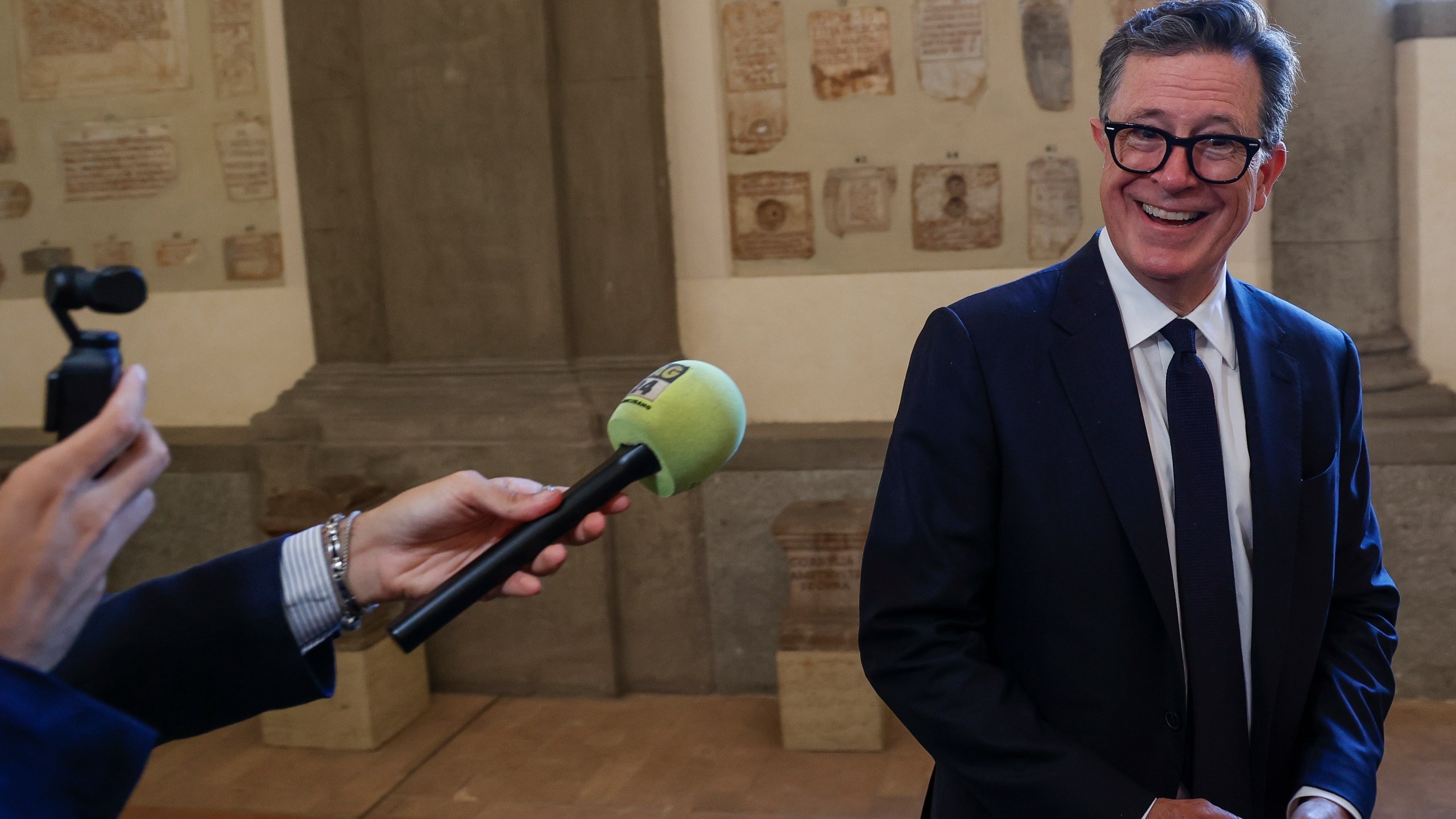 CAPTION CORRECTS LOCATION Stephen Colbert is interviewed after an audience with Pope Francis in Clementine Hall at The Vatican, Friday, June 14, 2024. Pope Francis is meeting with over 100 comedians from 15 countries aiming to establish a link between the Catholic Church and comic artists. (AP Photo/Riccardo De Luca)