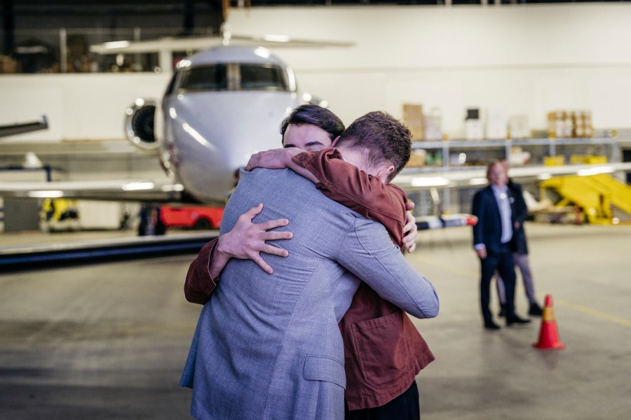 In this photo provided by the Swedish government, Johan Floderus reunites with his family at Arlanda airport in Stockholm, Sweden on Saturday, June 15, 2024, after being released from prison in Iran. (Tom Samuelsson/Swedish government/TT News Agency via AP)