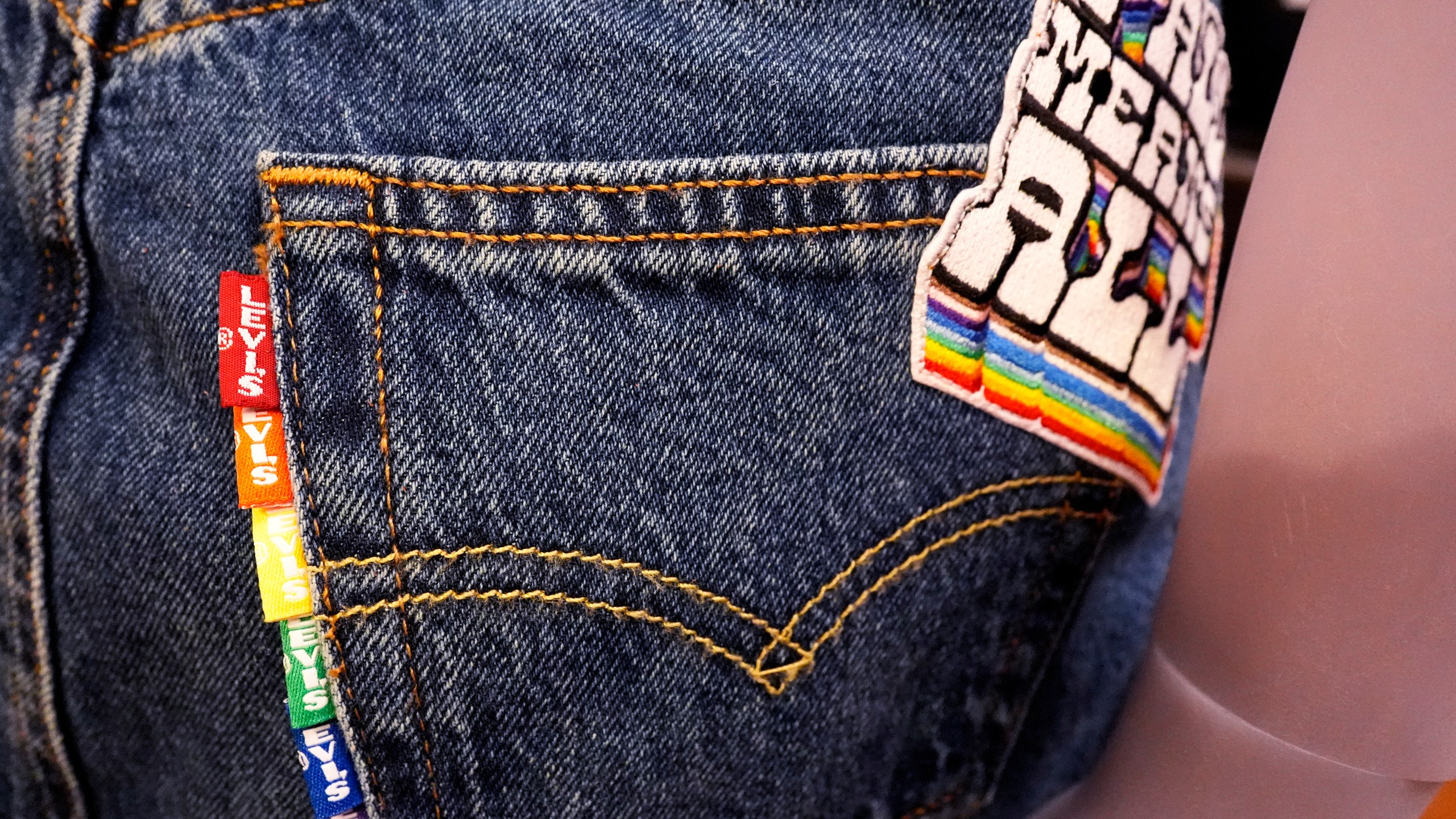 A jean skirt is displayed with a 2024 Levi's Pride collection patch and tabs at Levi's Store in downtown Chicago, Monday, June 10, 2024. Many big retailers, including Levi's, Target, Old Navy and Urban Outfitters, have put out Pride collections for years. (AP Photo/Nam Y. Huh)