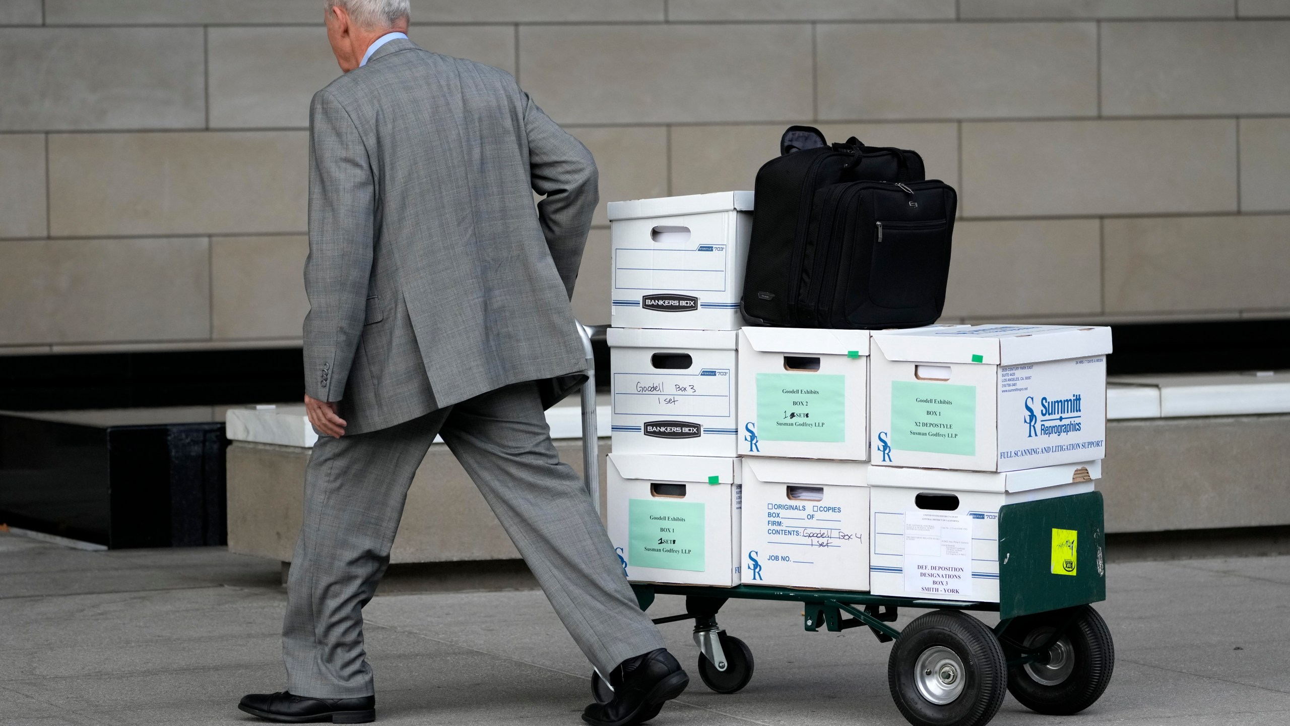 Case documents are wheeled into federal court Monday, June 17, 2024, in Los Angeles. NFL Commissioner Roger Goodell and Dallas Cowboys owner Jerry Jones, a longtime member of the league's broadcast committee, are expected to testify in a trial that could last up to three weeks. (AP Photo/Damian Dovarganes)