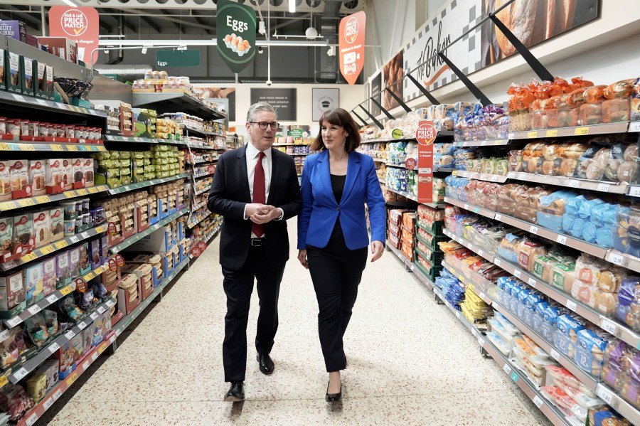 Labour Party leader Keir Starmer, left, and shadow chancellor Rachel Reeves to a supermarket while on the general election campaign trail, in Wiltshire, England, Wednesday, June 19, 2024. (Stefan Rousseau/PA via AP)