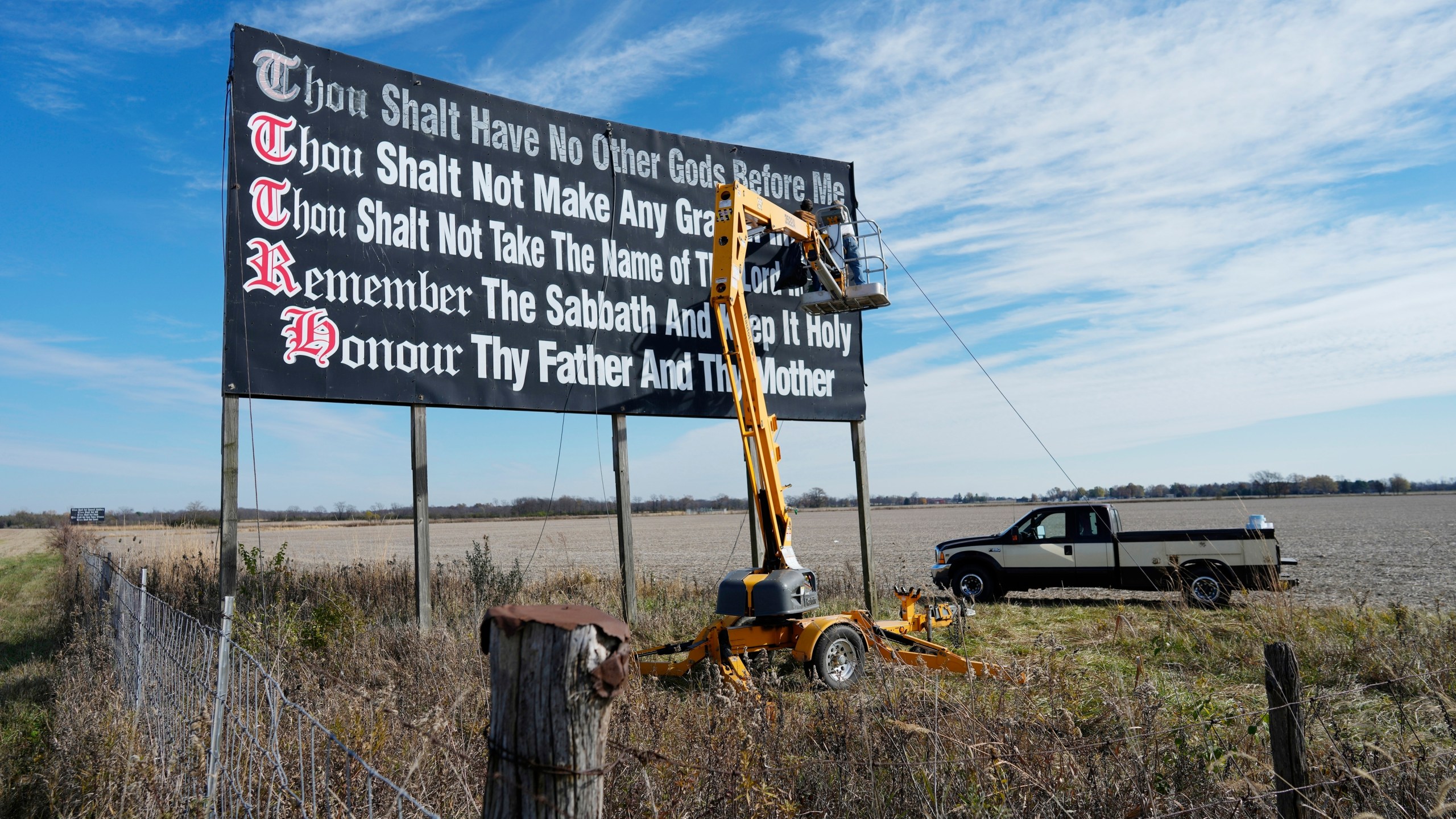 FILE - Workers repaint a Ten Commandments billboard off of Interstate 71 on Election Day near Chenoweth, Ohio, Tuesday, Nov. 7, 2023. Louisiana has become the first state to require that the Ten Commandments be displayed in every public school classroom under a bill signed into law by Republican Gov. Jeff Landry on Wednesday. (AP Photo/Carolyn Kaster, File)