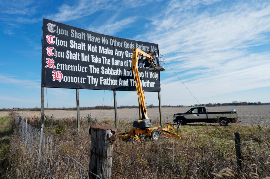 FILE - Workers repaint a Ten Commandments billboard off of Interstate 71 on Election Day near Chenoweth, Ohio, Tuesday, Nov. 7, 2023. Louisiana has become the first state to require that the Ten Commandments be displayed in every public school classroom under a bill signed into law by Republican Gov. Jeff Landry on Wednesday. (AP Photo/Carolyn Kaster, File)