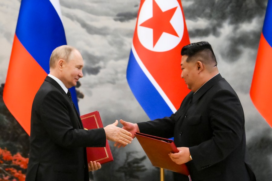 Russian President Vladimir Putin, left, and North Korea's leader Kim Jong Un exchange documents during a signing ceremony of the new partnership in Pyongyang, North Korea, on Wednesday, June 19, 2024. Putin and Kim signed a new partnership that includes a vow of mutual aid if either country is attacked, during a Wednesday summit that came as both face escalating standoffs with the West. (Kristina Kormilitsyna, Sputnik, Kremlin Pool Photo via AP)