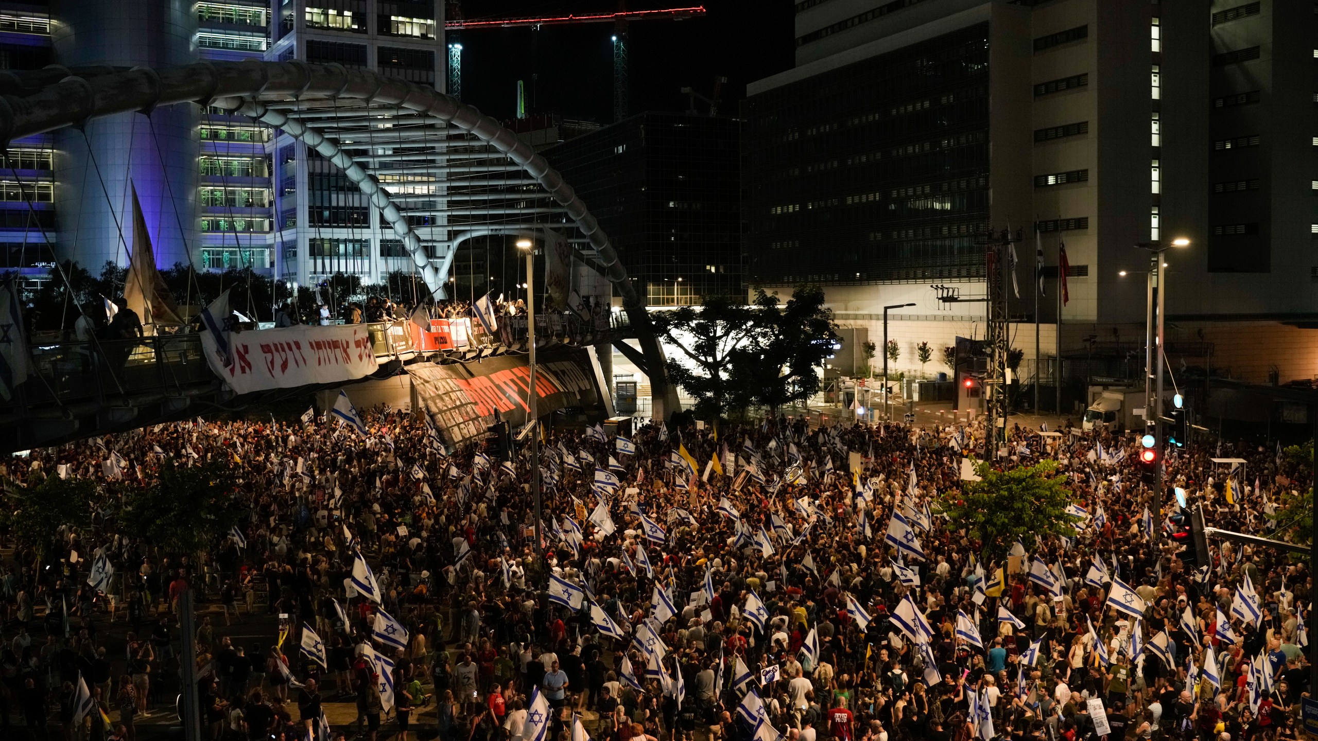 People protest against Israeli Prime Minister Benjamin Netanyahu's government and call for the release of hostages held in the Gaza Strip by the Hamas militant group, in Tel Aviv, Israel, Saturday, June 22, 2024. (AP Photo/Leo Correa)