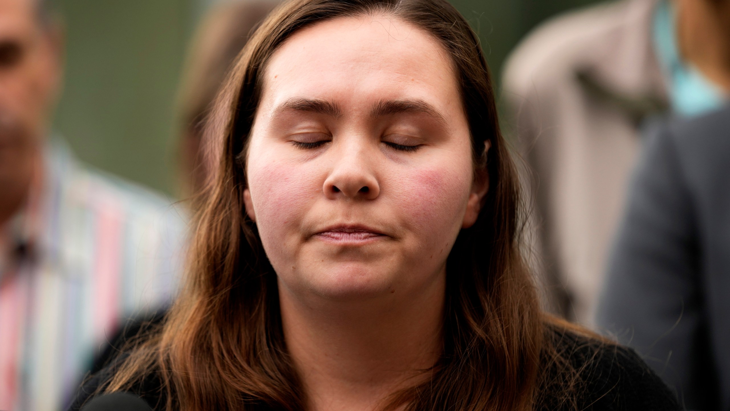 Leah Sundheim, whose mother Jacquelyn was killed, closes her eyes as she speaks at a news conference after the hearing of Robert E. Crimo III., at the Lake County Courthouse in Waukegan, Ill., Wednesday, June 26, 2024. Crimo III is charged with killing seven people and wounding dozens more in a shooting at an Independence Day parade in the suburban Chicago town of Highland Park, Ill. (AP Photo/Nam Y. Huh)