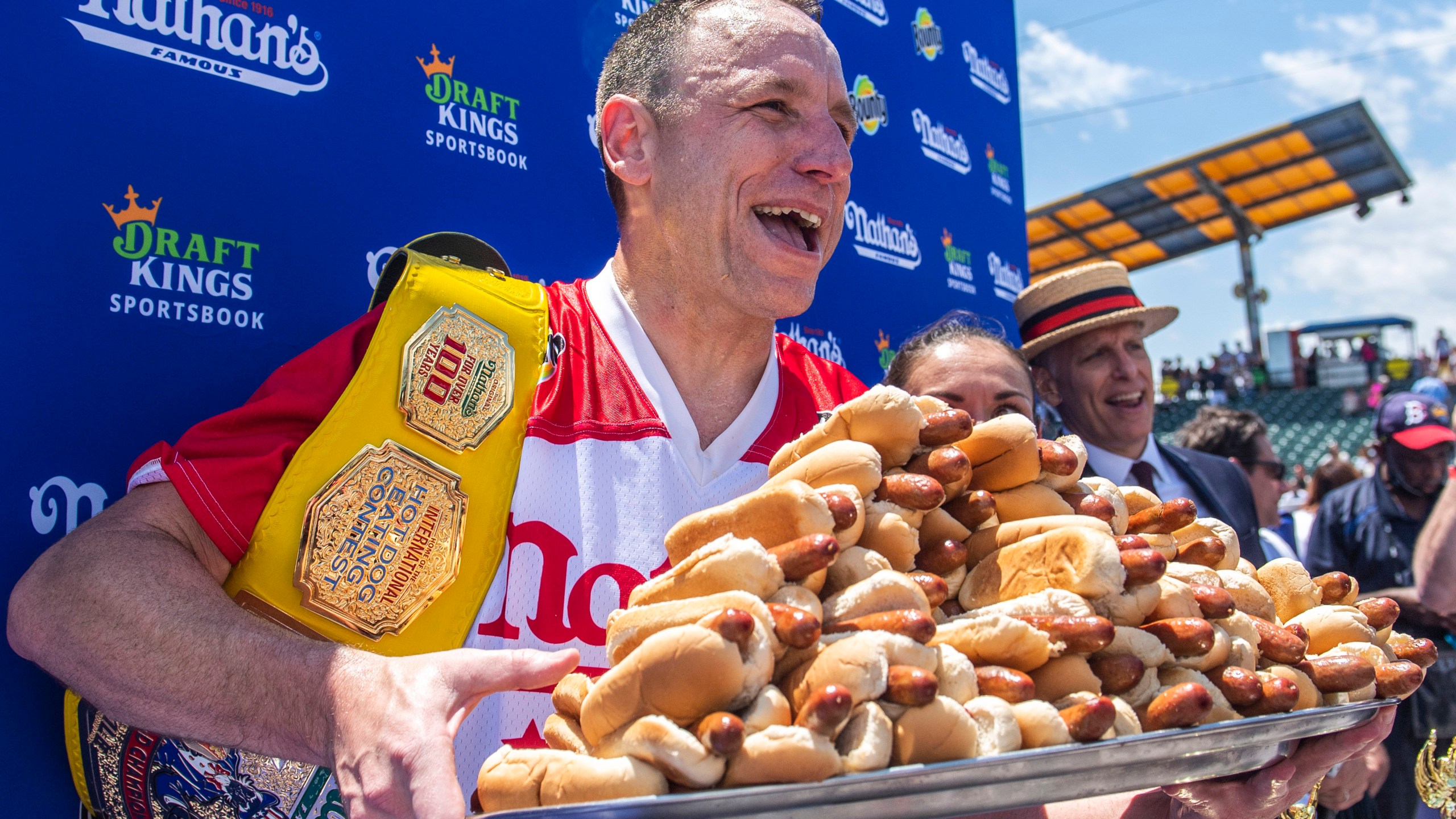 FILE - Joey Chestnut, winner of the 2021 Nathan's Famous Fourth of July International Hot Dog-Eating Contest, poses for photos in Coney Island's Maimonides Park, July 4, 2021, in the Brooklyn borough of New York. Chestnut will take his hot dog-downing talents to an army base in Texas for America's Independence Day this year, after a falling out with organizers of the annual New York City-based event. (AP Photo/Brittainy Newman, File)