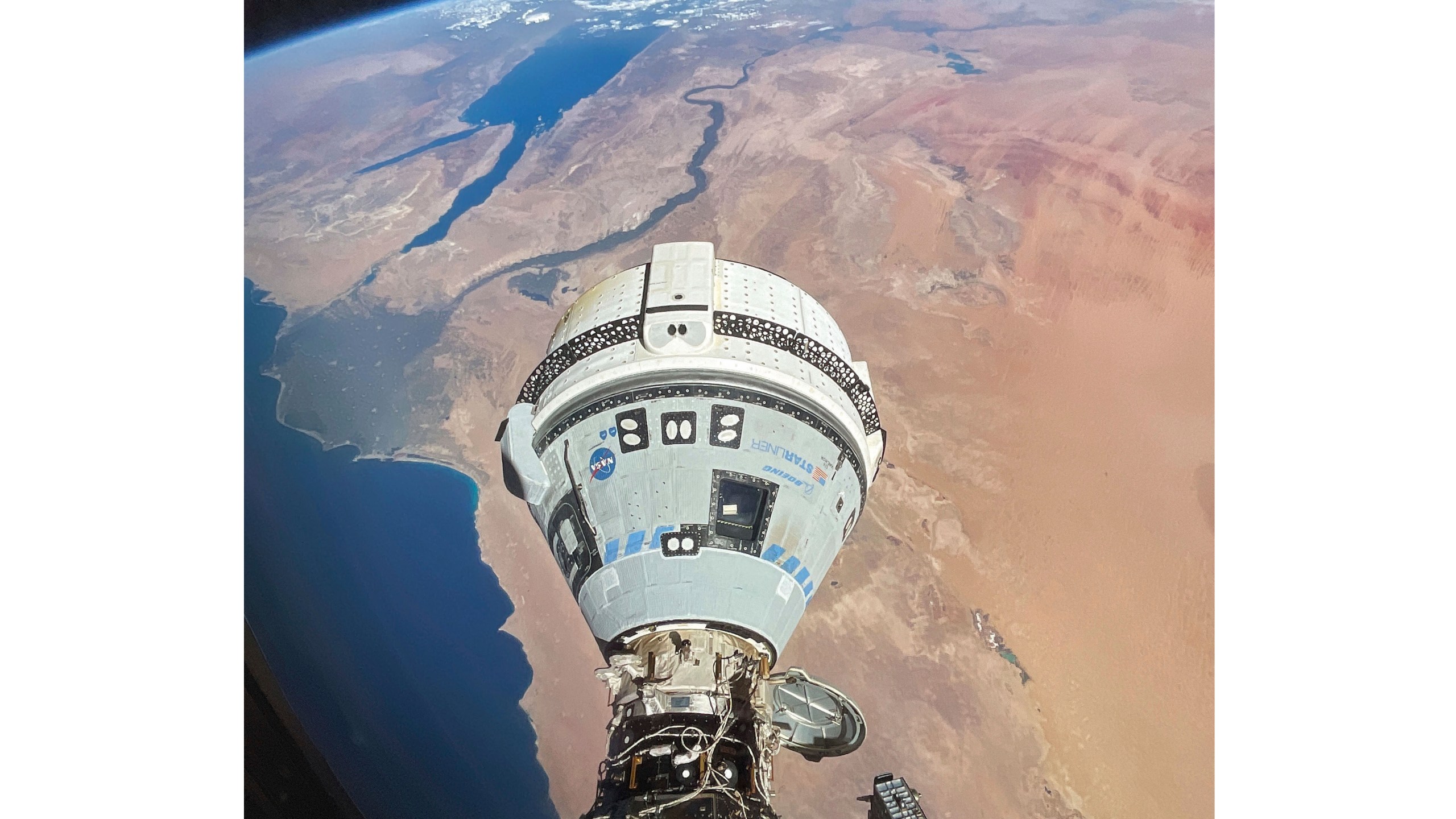 This photo provided by NASA shows the Starliner spacecraft docked to the Harmony module of the International Space Station, orbiting 262 miles above Egypt's Mediterranean coast, on June 13, 2024. (NASA via AP)