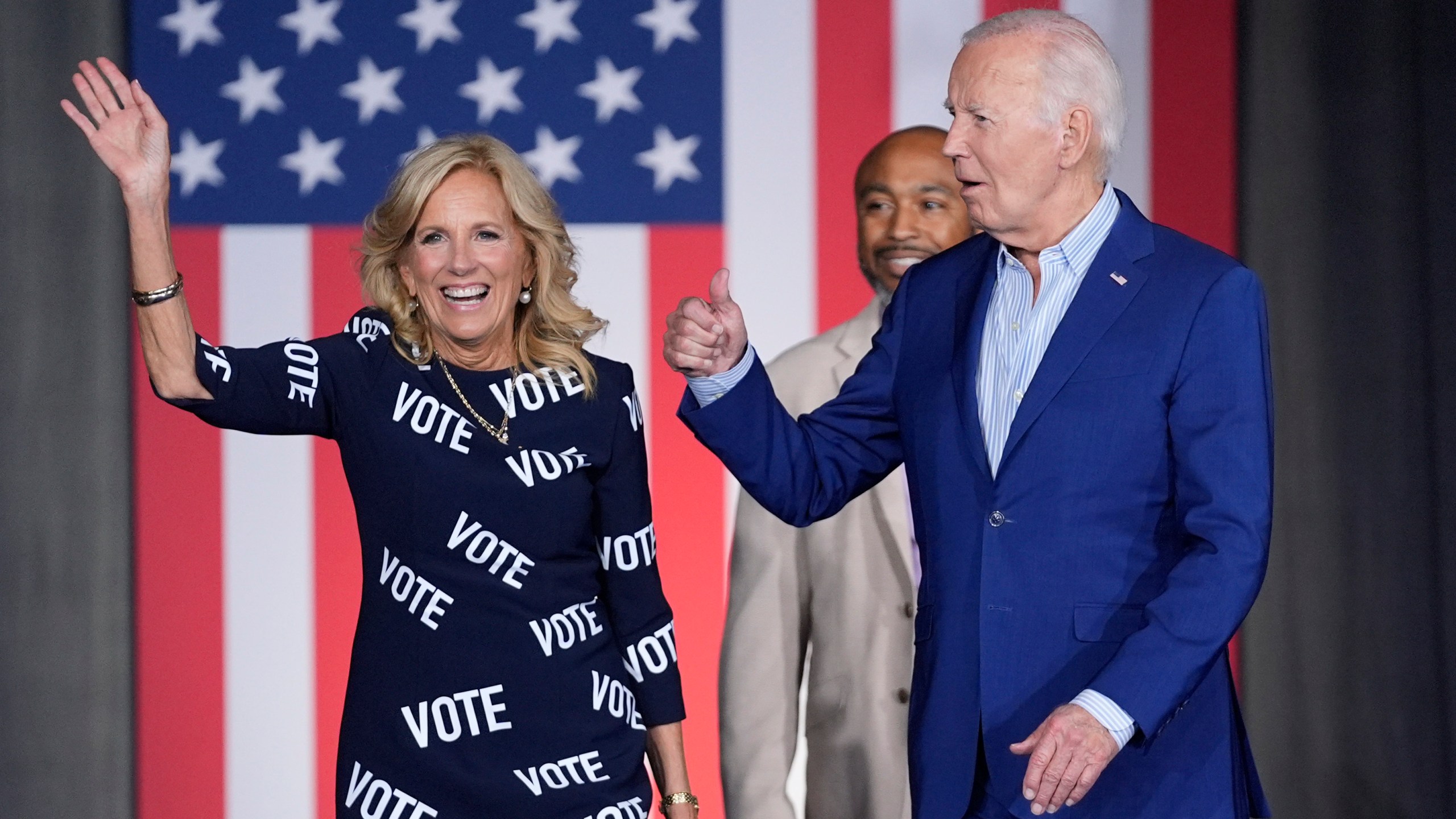 President Joe Biden, right, and first lady Jill Biden, left, walk to the stage to speak at a campaign rally, joined in background by Eric Fitts, Friday, June 28, 2024, in Raleigh, N.C. (AP Photo/Evan Vucci)