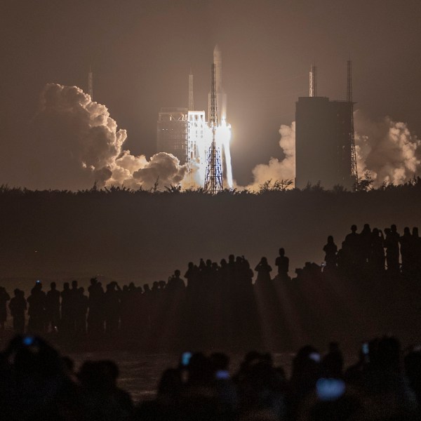 A Chinese rocket carrying a lunar probe launches at night from China's Wenchang Space Center.