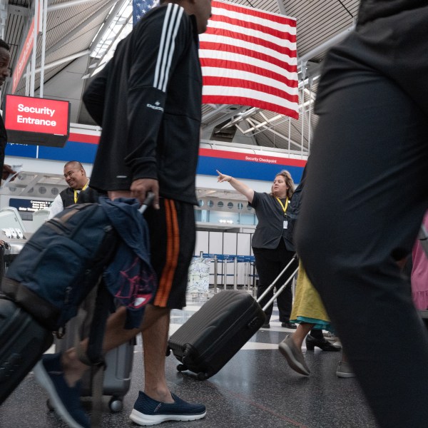 Passengers pass through O'Hare Airport during the start of the Independence Day travel week on June 28, 2024.