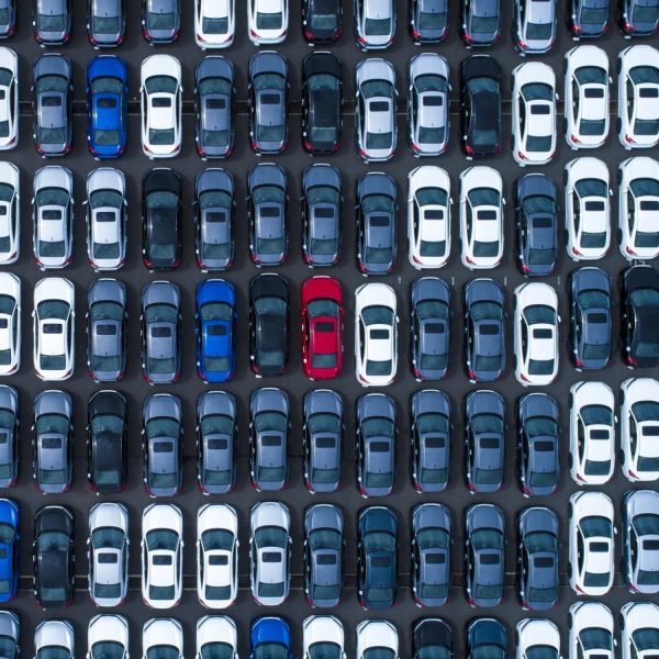 Different colored cars at a parking lot.