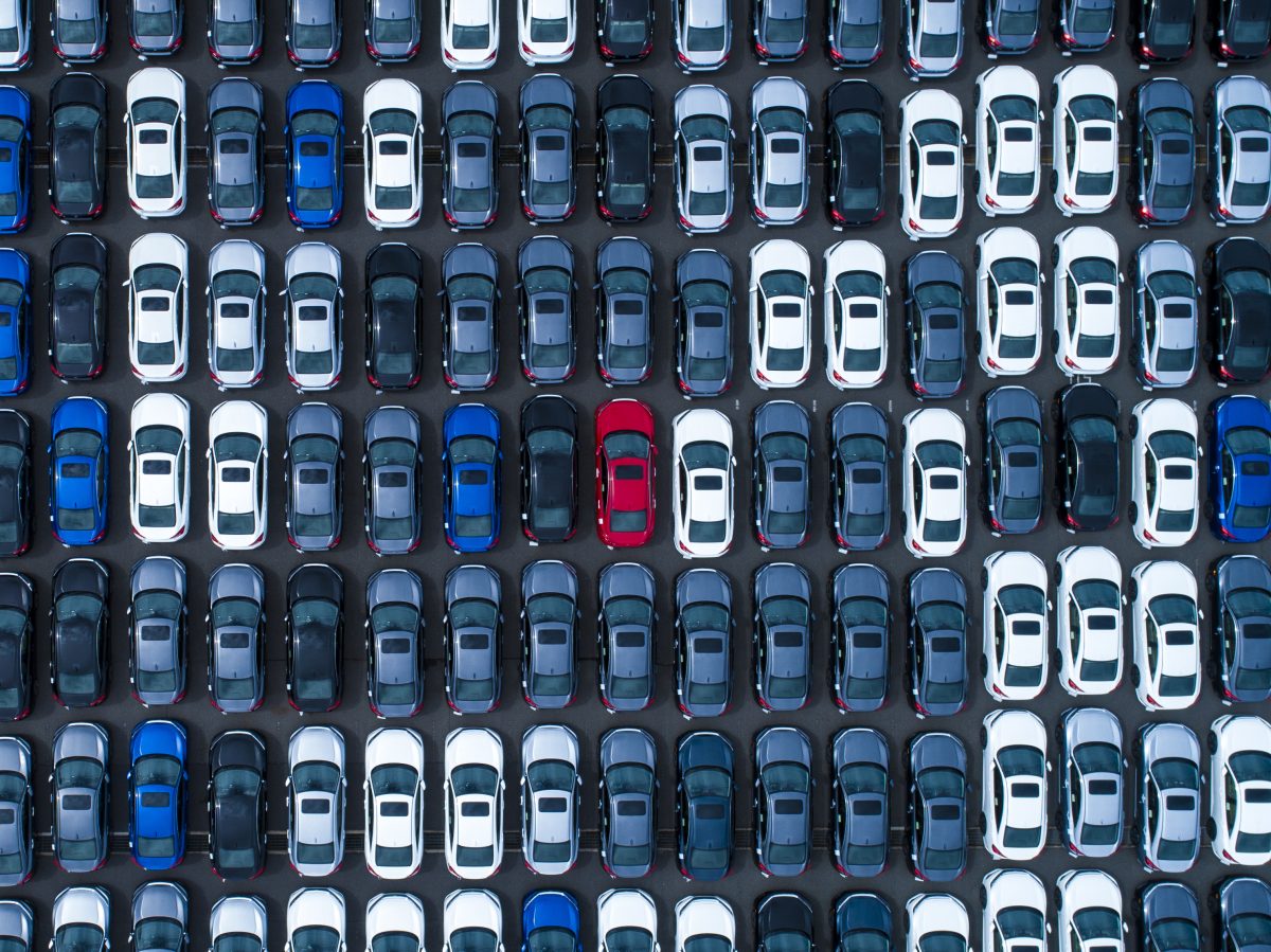 Different colored cars at a parking lot.