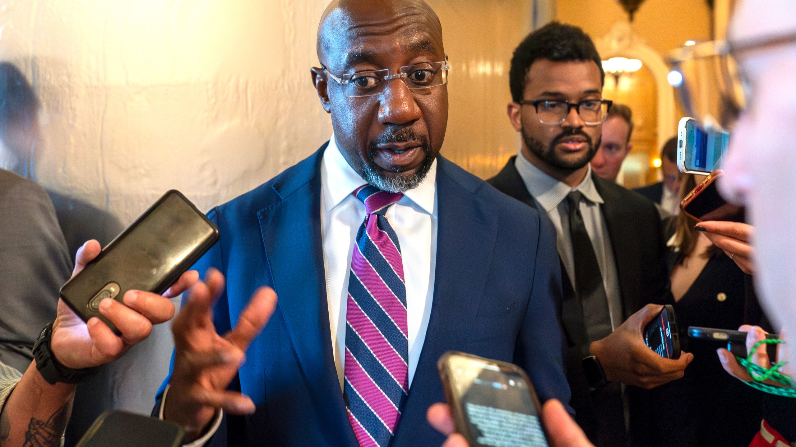 FILE - Sen. Raphael Warnock, D-Ga., speaks with reporters, Sept. 28, 2023, in Washington. Senior Democratic figures rallied publically around President Joe Biden on Sunday, June 30, 2024, amid private angst within the party about Thursday's debate performance. Warnock said during NBC's "Meet The Press," there had been "more than a few Sundays, when I wish I had preached a better sermon, but after the sermon was over it was my job to embody the message, to show up for the people that I serve. And that's what Joe Biden has been doing his entire life." (AP Photo/Alex Brandon, File)