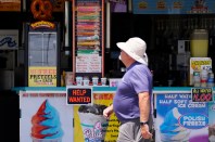 FILE - A person walks past an ice cream stand on the boardwalk, Thursday, June 2, 2022, in Ocean City, N.J. A type of bankruptcy protection filing that made it easier for small businesses to seek relief has expired, which will complicate filing for small businesses with more than $3 million in debt. (AP Photo/Matt Slocum, File)