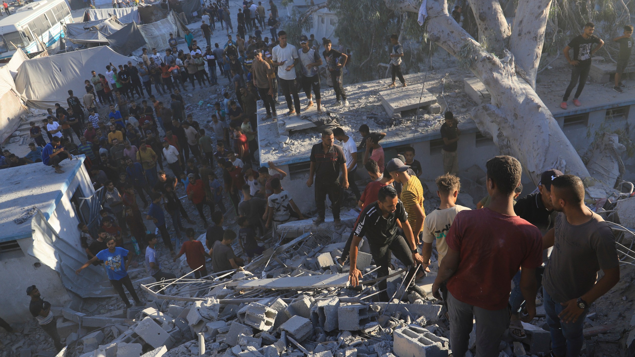 Palestinians search for bodies and survivors in the rubble of a residential building destroyed in an Israeli airstrike in Khan Younis, Gaza Strip, Wednesday, July 3, 2024. (AP Photo /Jehad Alshrafi)