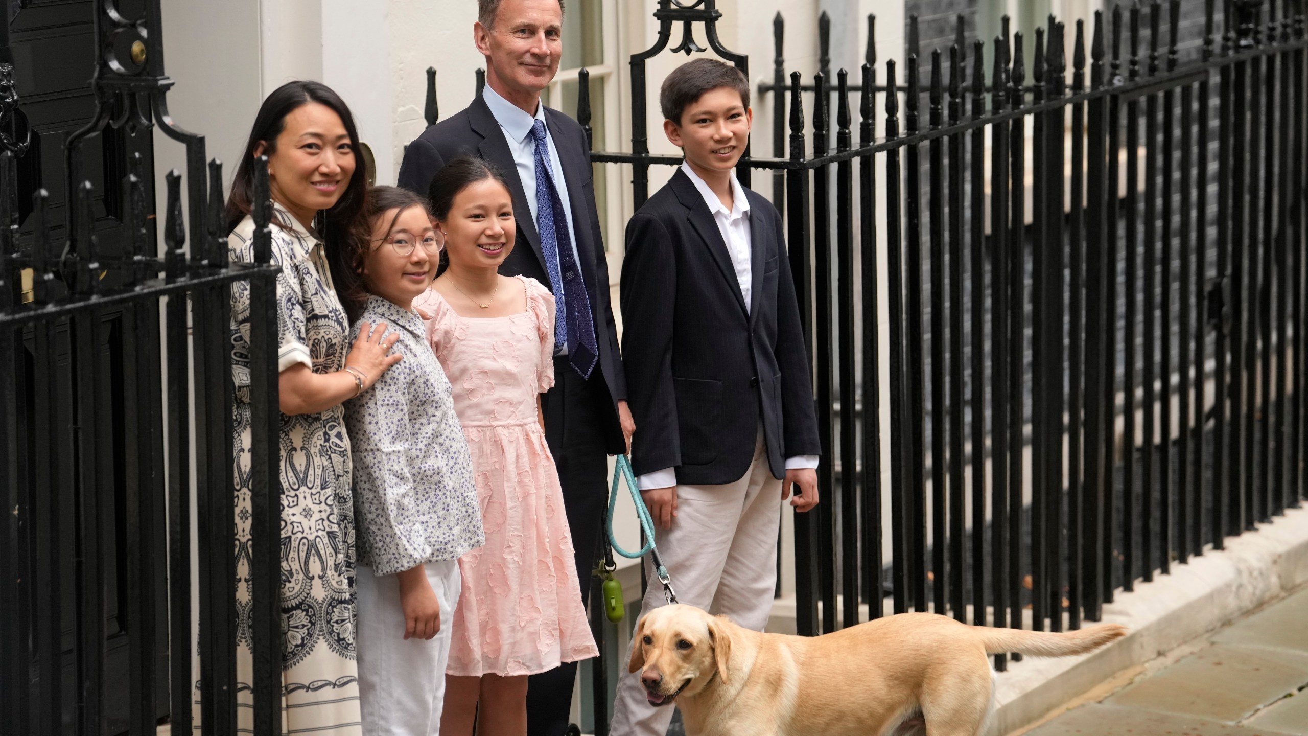 Outgoing Conservative chancellor of the exchequer Jeremy Hunt, with his wife Lucia Hunt and their children Jack, Anna and Eleanor leave 11 Downing Street after the Labour party won a landslide victory in the general election, Friday, July 5, 2024. Britain's Labour Party swept to power Friday after more than a decade in opposition, as a jaded electorate handed the party a landslide victory — but also a mammoth task of reinvigorating a stagnant economy and dispirited nation. (AP Photo/Vadim Ghirda)