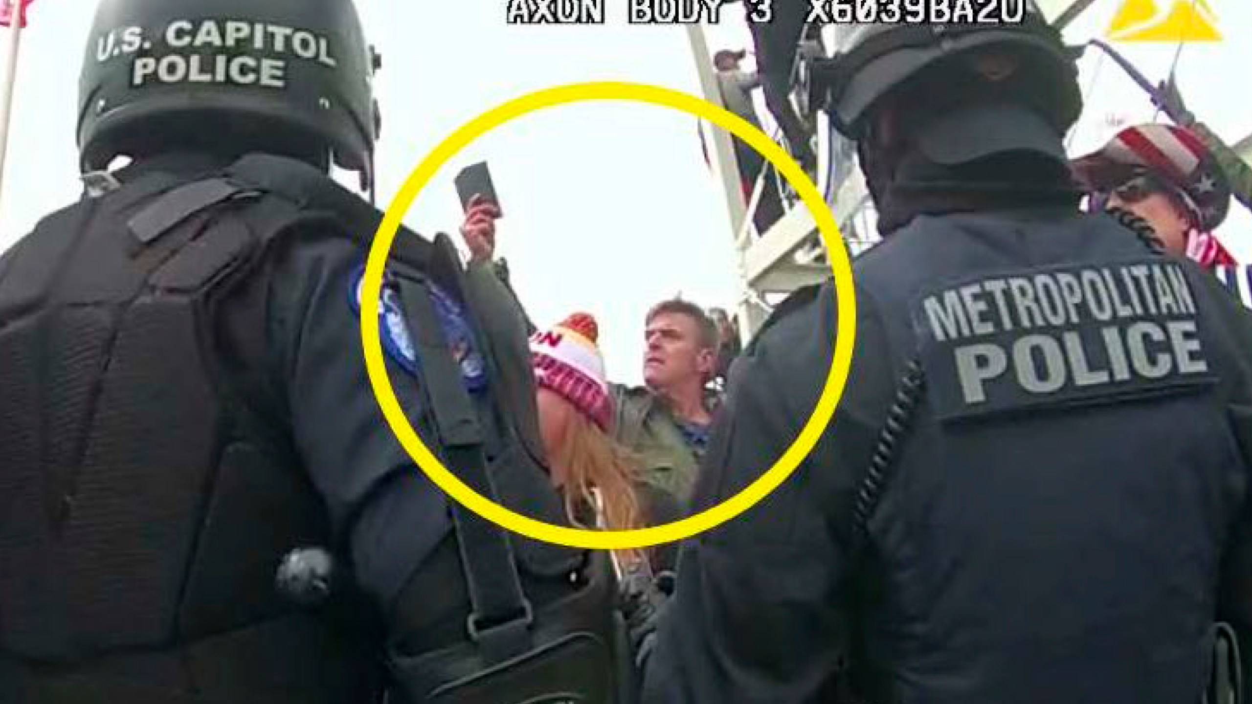 FILE - This image from Washington Metropolitan Police Department body-worn video, released and annotated by the Justice Department in the statement of facts supporting an arrest warrant for Jay James Johnston, shows Johnston, circled in yellow, at the U.S. Capitol on Jan. 6, 2021, in Washington. Johnston, an actor known for comedic roles in the movie “Anchorman” and the television series “Bob’s Burgers” has pleaded guilty to interfering with police officers trying to protect the U.S. Capitol from a mob’s attack. Johnston faces a maximum sentence of five years in prison after pleading guilty on Monday to a felony count of civil disorder. (Justice Department via AP, File)