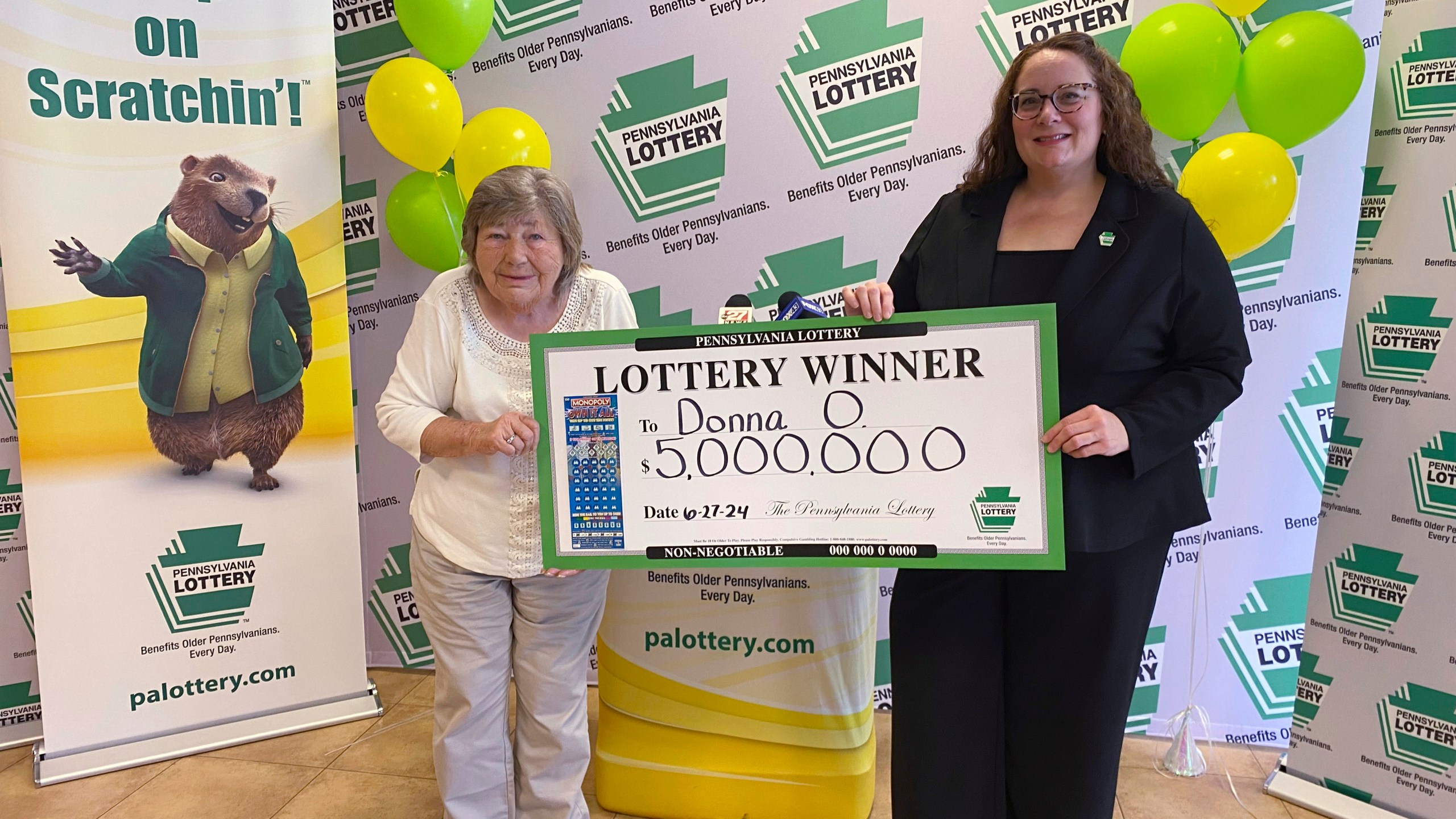 This image provided by the Pennsylvania Lottery shows Donna Osborne, 75, left, posing for a photo with PA Lottery Deputy Director of Corporate Sales Staci Coombs at Lottery Headquarters in Middletown, Pa. (Pennsylvania Lottery via AP)