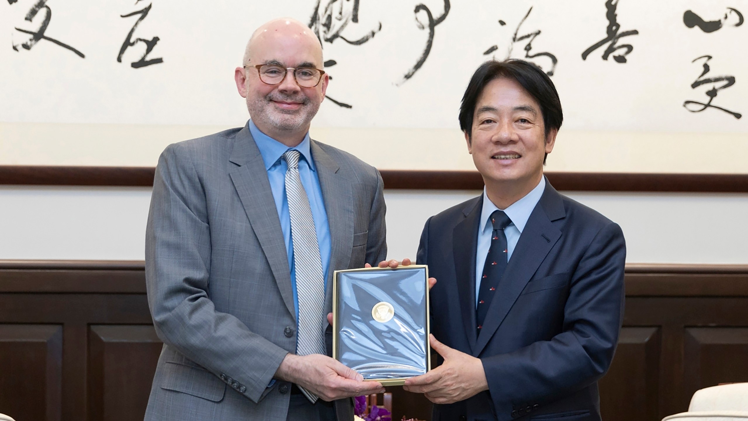 In this photo released by the Taiwan Presidential Office, Taiwan's President William Lai Ching-te, right pose for photos with American Institute in Taiwan's (AIT) director Raymond F. Greene in Taipei, Taiwan on July 10, 2024. Raymond who newly assumed his office on July 9, met with Taiwan President William Lai in the morning of July 10, when both reiterated on the strong partnership Taiwan and the U.S. nurtured from the past, with ups and downs. (Taiwan Presidential Office via AP)