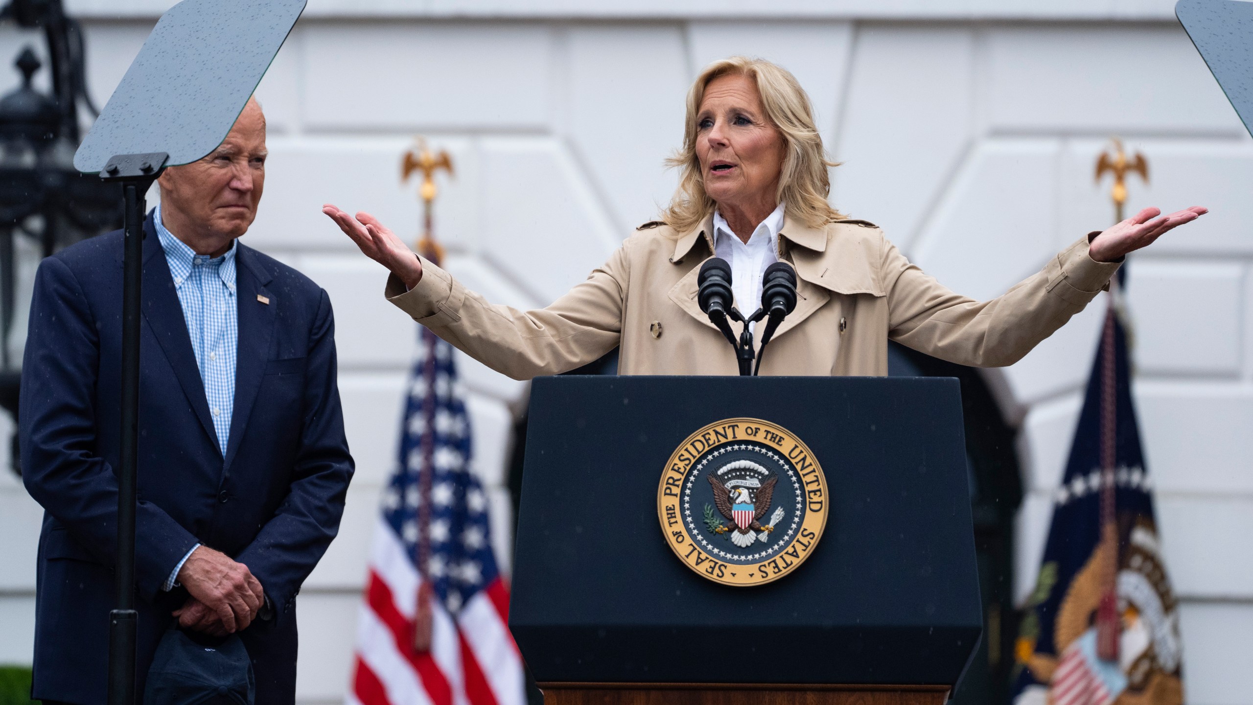 President Joe Biden listens as first lady Jill Biden speaks during a barbecue with active-duty military service members and their families on the South Lawn of the White House, Thursday, July 4, 2024, in Washington. (AP Photo/Evan Vucci)