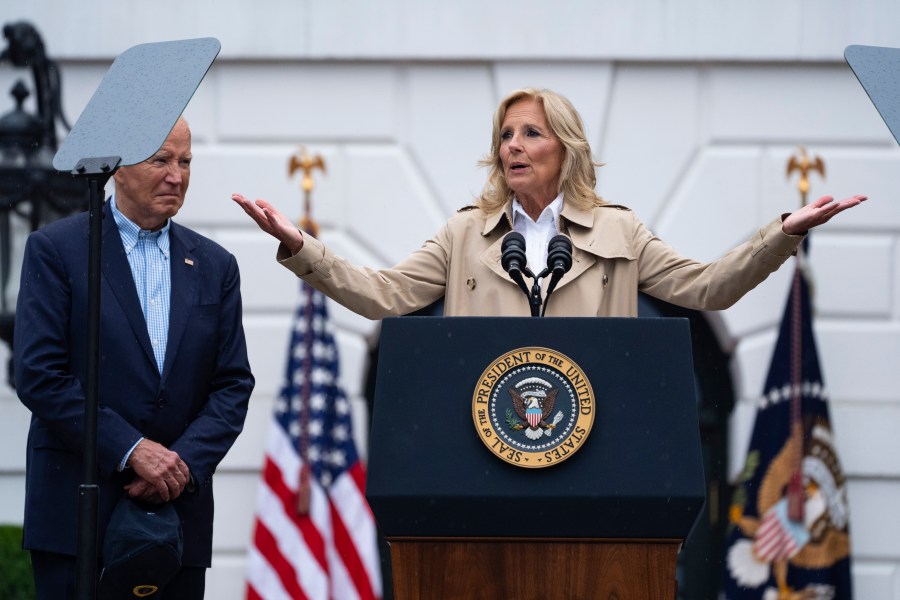 President Joe Biden listens as first lady Jill Biden speaks during a barbecue with active-duty military service members and their families on the South Lawn of the White House, Thursday, July 4, 2024, in Washington. (AP Photo/Evan Vucci)