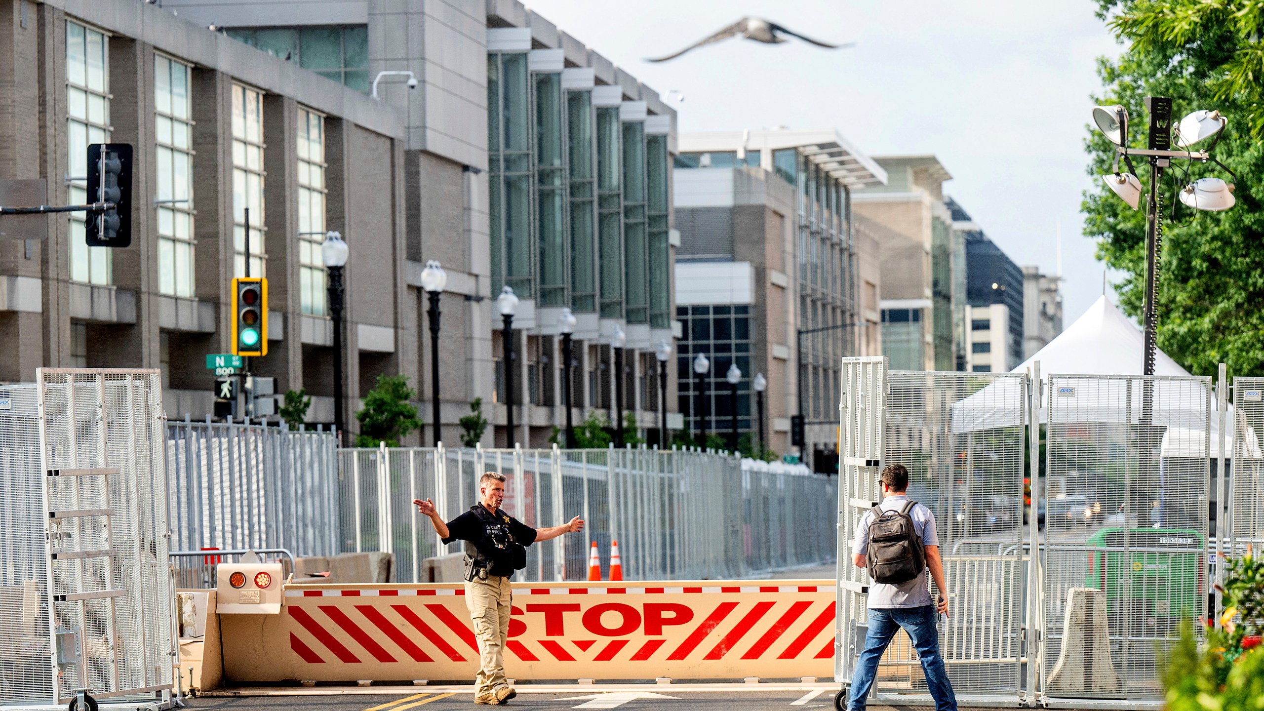 A U.S. Secret Service agent directs a pedestrian around a security perimeter at the NATO summit, in Washington, Wednesday, July 10, 2024. (AP Photo/Noah Berger)