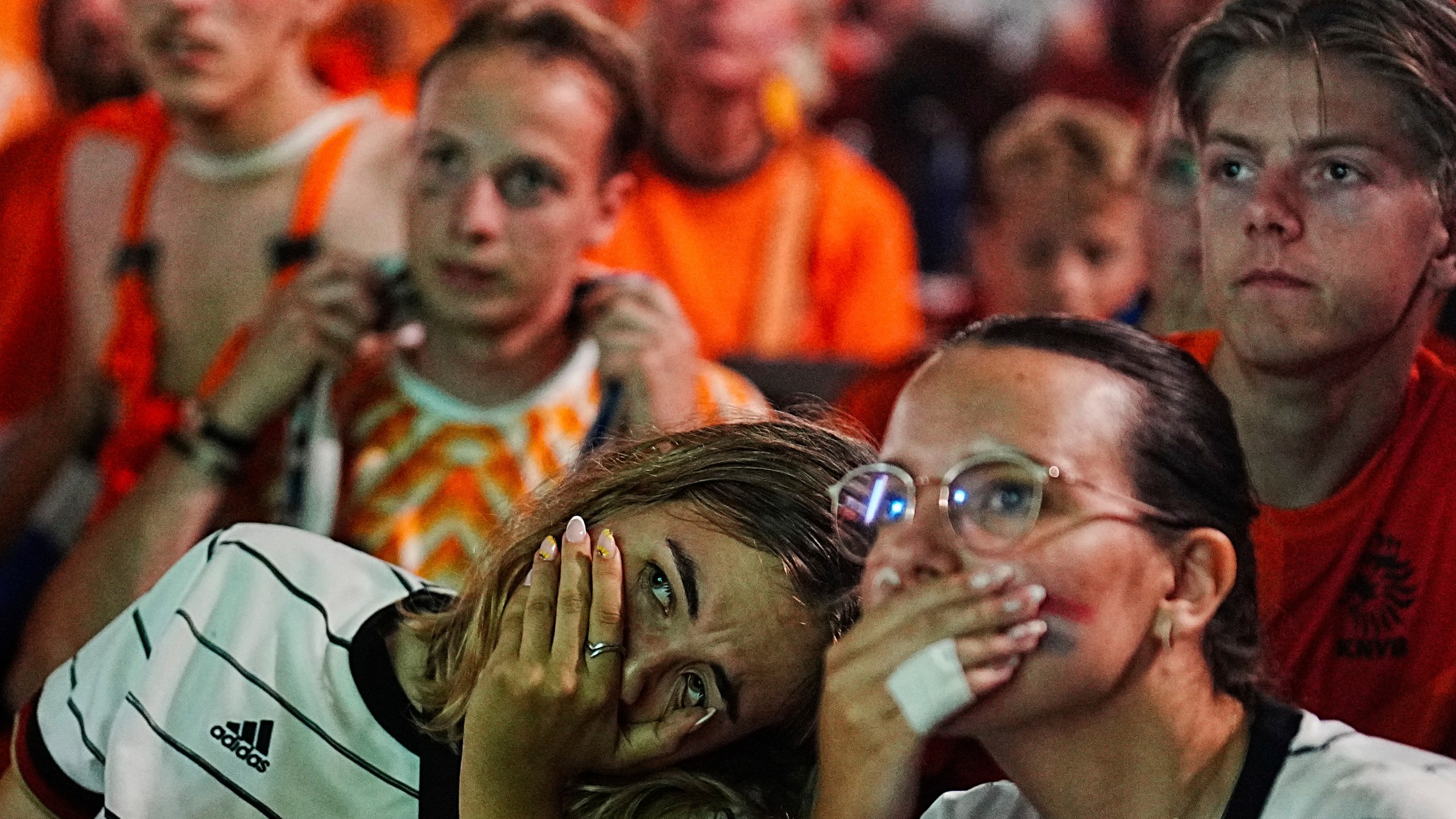 Netherlands soccer fans react at a pubic screening at the end of a semi final match between Netherlands and England at the Euro 2024 soccer tournament in Dortmund, Germany, Wednesday, July 10, 2024. (AP Photo/Markus Schreiber)