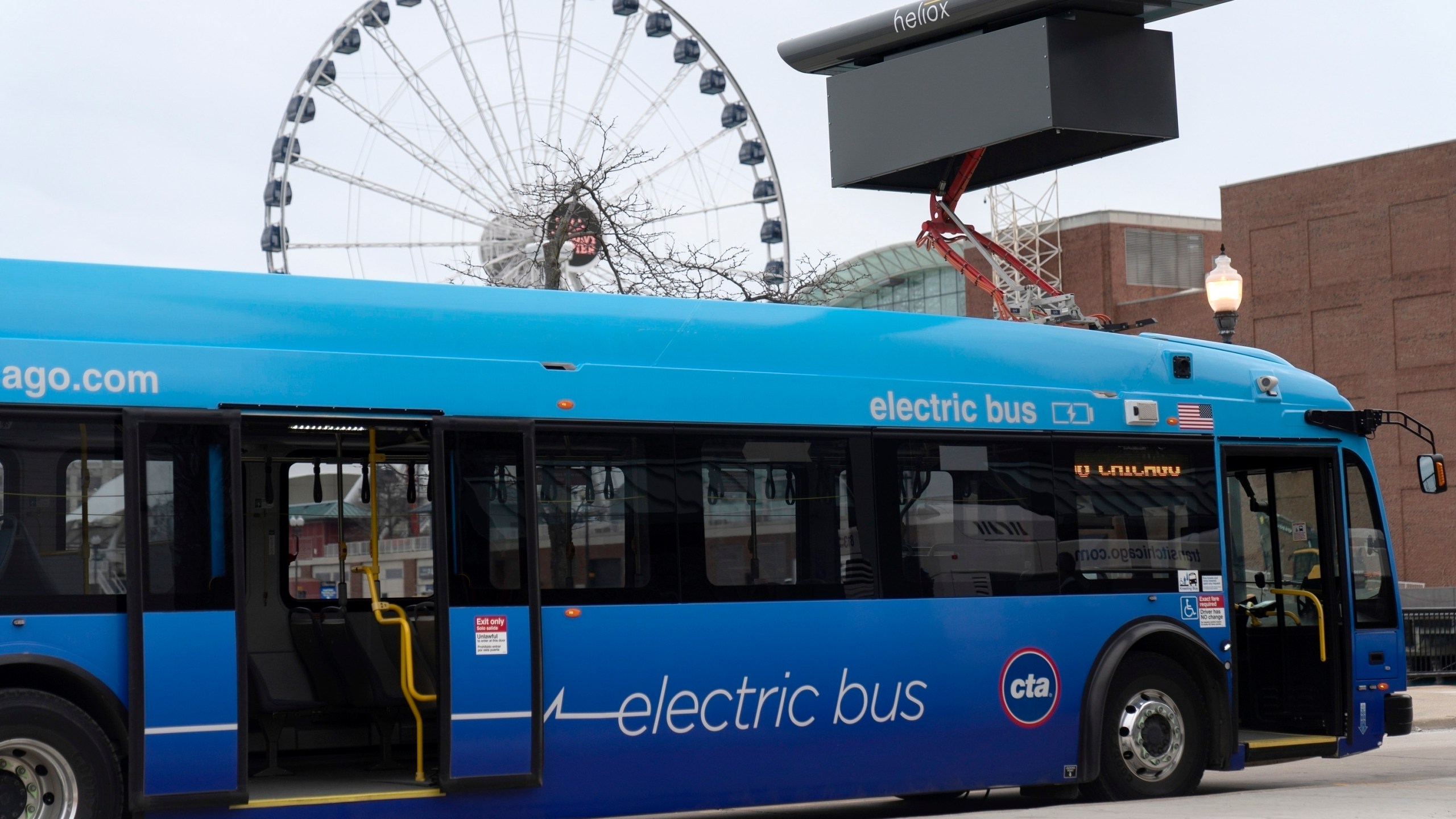 FILE - A Chicago Transit Authority electric bus charges at Navy Pier Tuesday, Feb. 14, 2023, in Chicago. The Biden administration is awarding nearly $2 billion in grants to help restart or expand electric vehicle manufacturing and assembly sites in eight states, including the presidential battlegrounds of Michigan, Pennsylvania and Georgia. Grants totaling $1.7 billion will be issued by the Energy Department to create or retain thousands of union jobs and support auto-based communities that have long driven the U.S. economy, the White House said Thursday, July 11, 2024. (AP Photo/Erin Hooley, File)