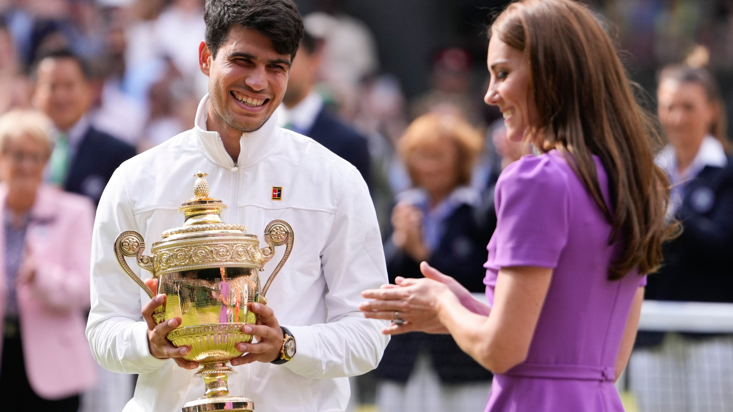 Carlos Alcaraz of Spain reacts after receiving his trophy from Kate, Princess of Wales after defeating Novak Djokovic of Serbia in the men's singles final at the Wimbledon tennis championships in London, Sunday, July 14, 2024. (AP Photo/Alberto Pezzali)