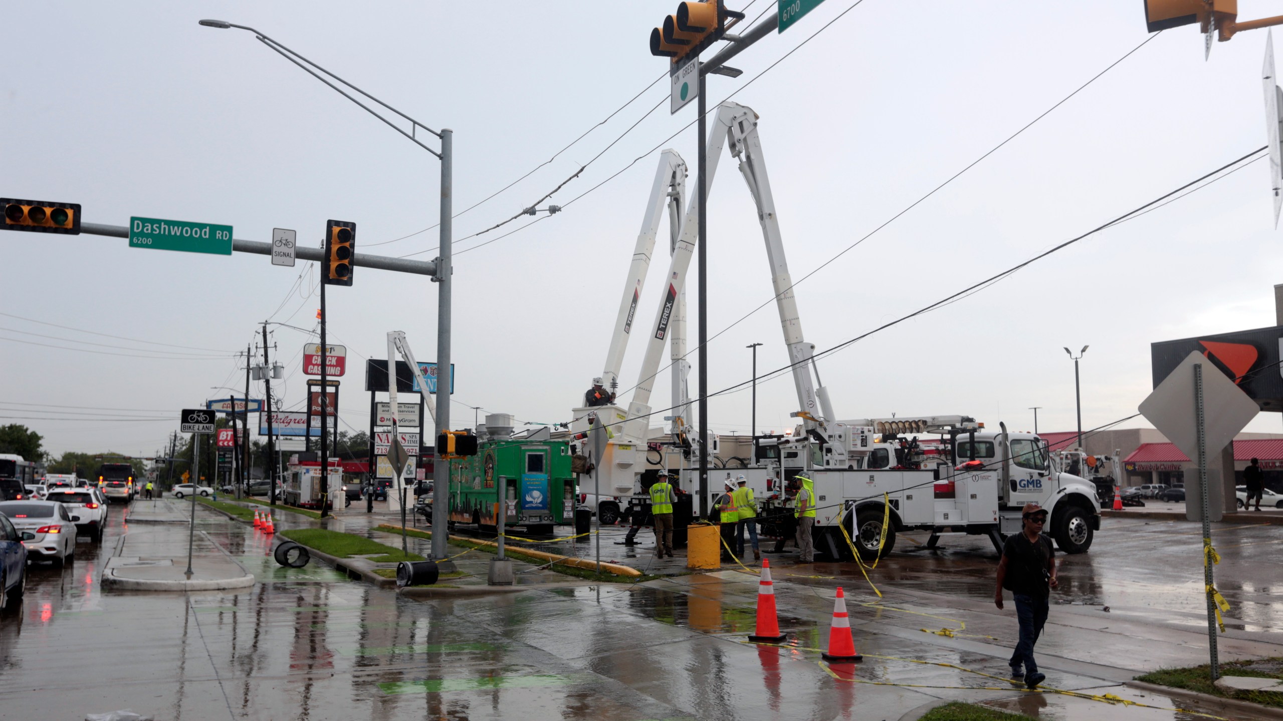 Utility crews work to restore electricity in Houston, Thursday, July 11, 2024. Officials say about 500,000 customers still won't have electricity into next week as wide outages from Hurricane Beryl persist. (AP Photo/Lekan Oyekanmi)